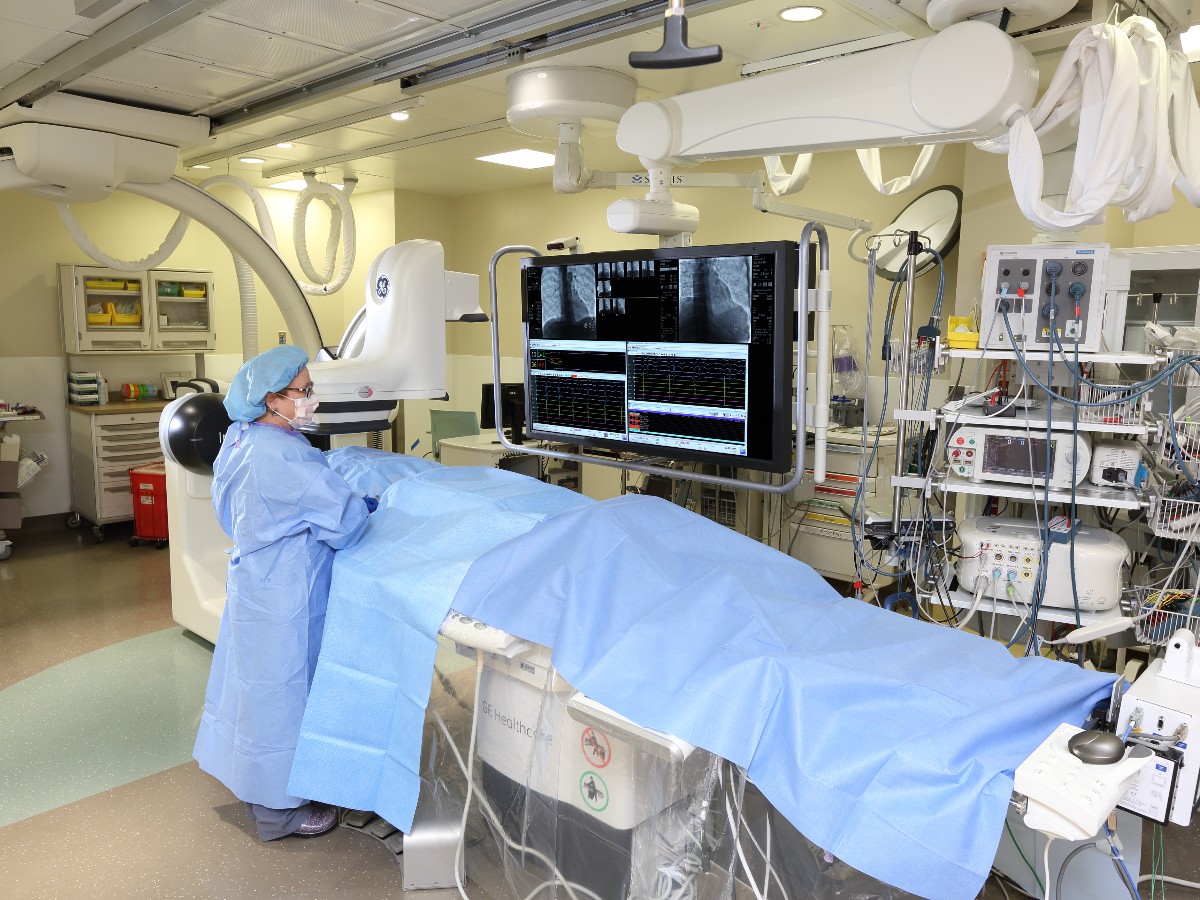 Physician performing an electrophysiology procedure on a patient in a cardiac catheterization laboratory 
