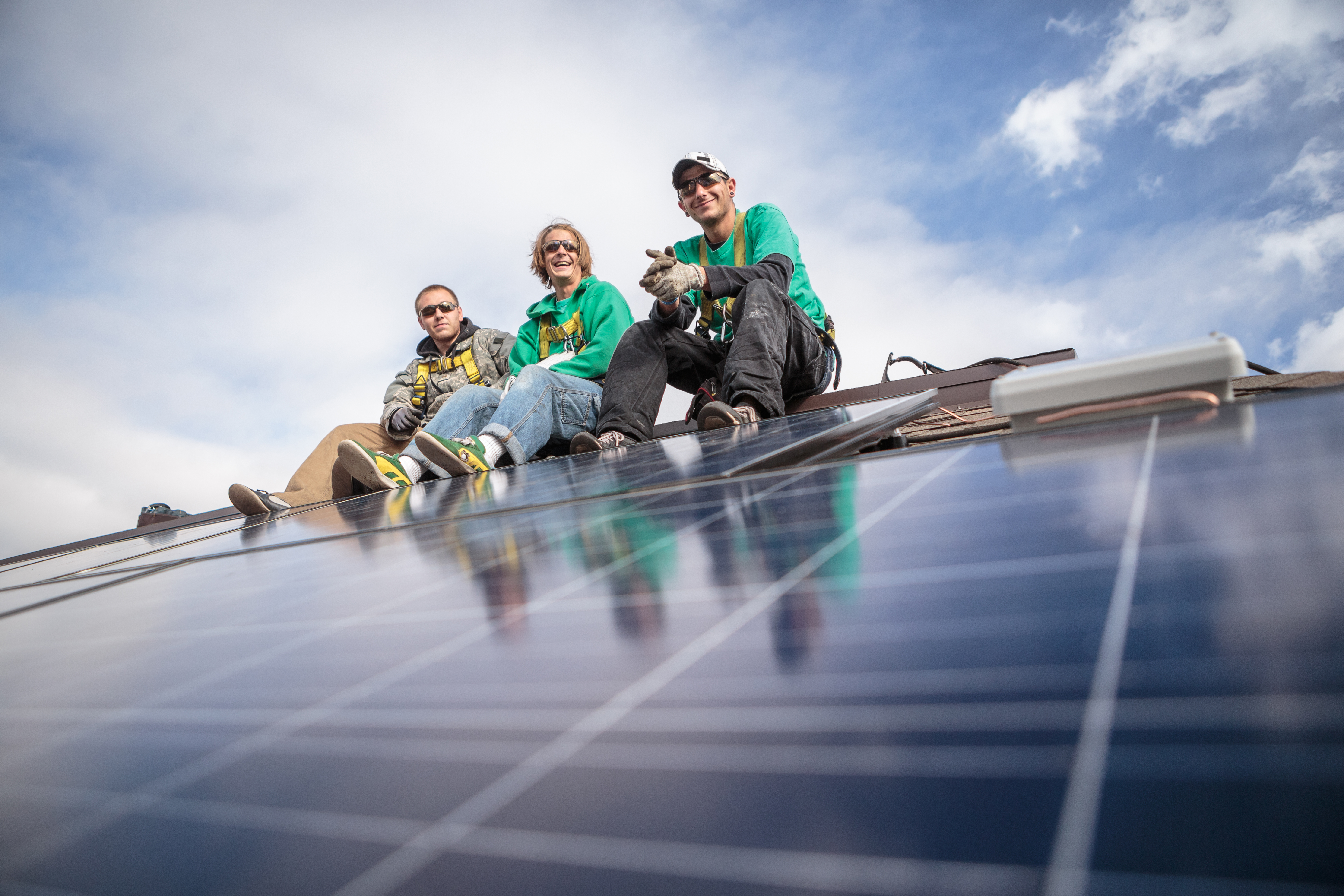 Construction crew taking break from installing solar panels on a house