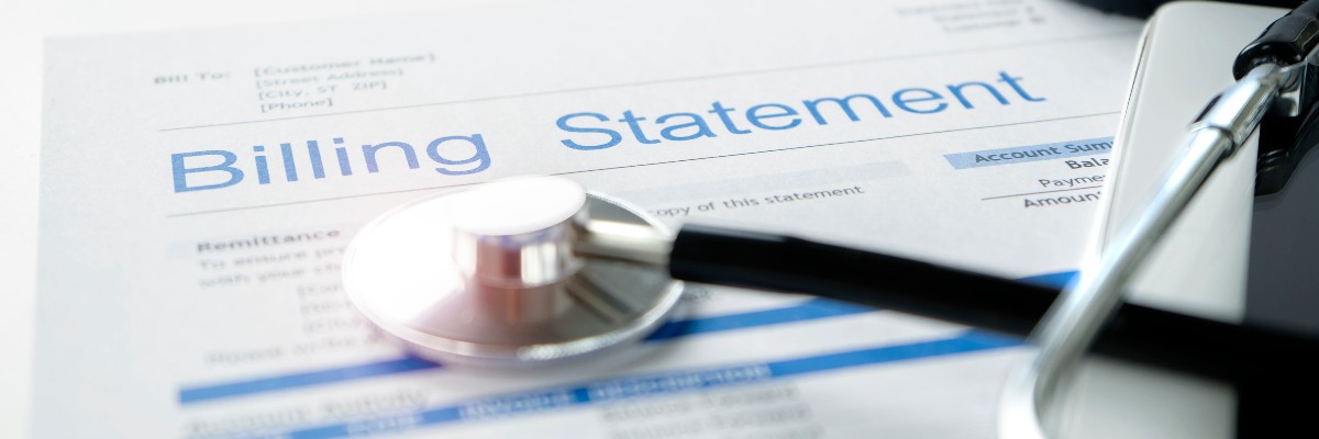 Health care billing statement with stethoscope, bottle of medicine for doctor's work in medical center stone background.