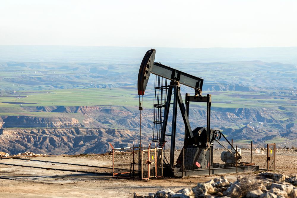 View of the pumpjack in the oil well of the oil field. The arrangement is commonly used for onshore wells producing little oil. Pumpjacks are common in oil-rich areas.