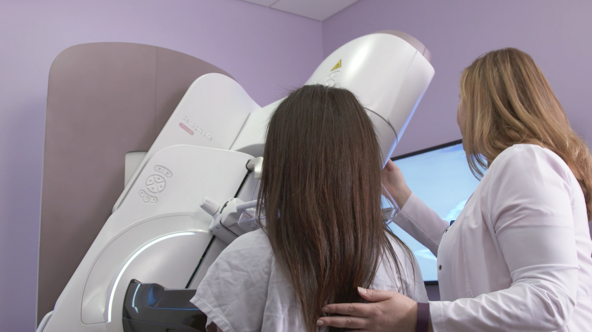 Patient and female technician using new GE Healthcare Pristina Dueta mammography imaging system