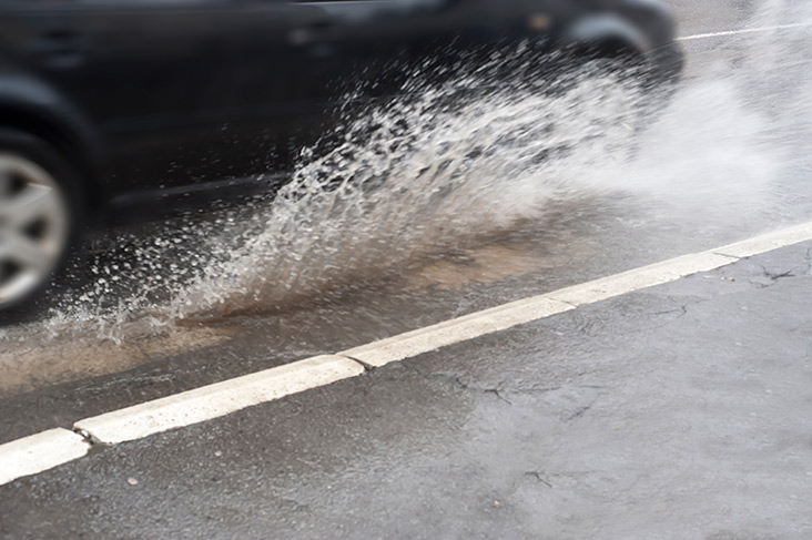 Car splashing through puddle