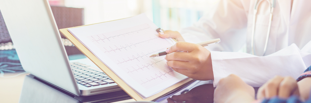 A doctor points out reciprocal depression on ECG.