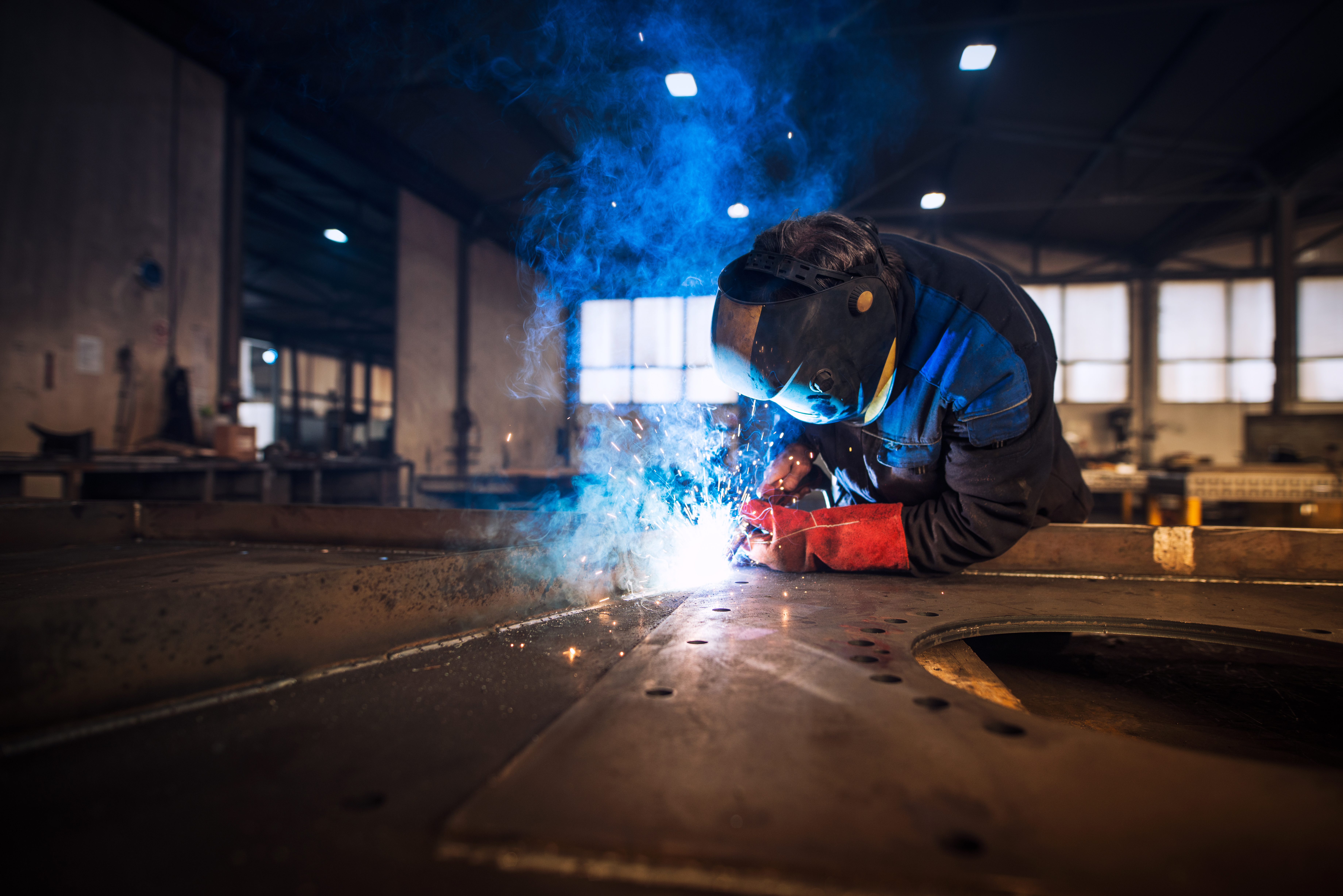 close-up-view-worker-welding-metal-construction-industrial-workshop.jpg