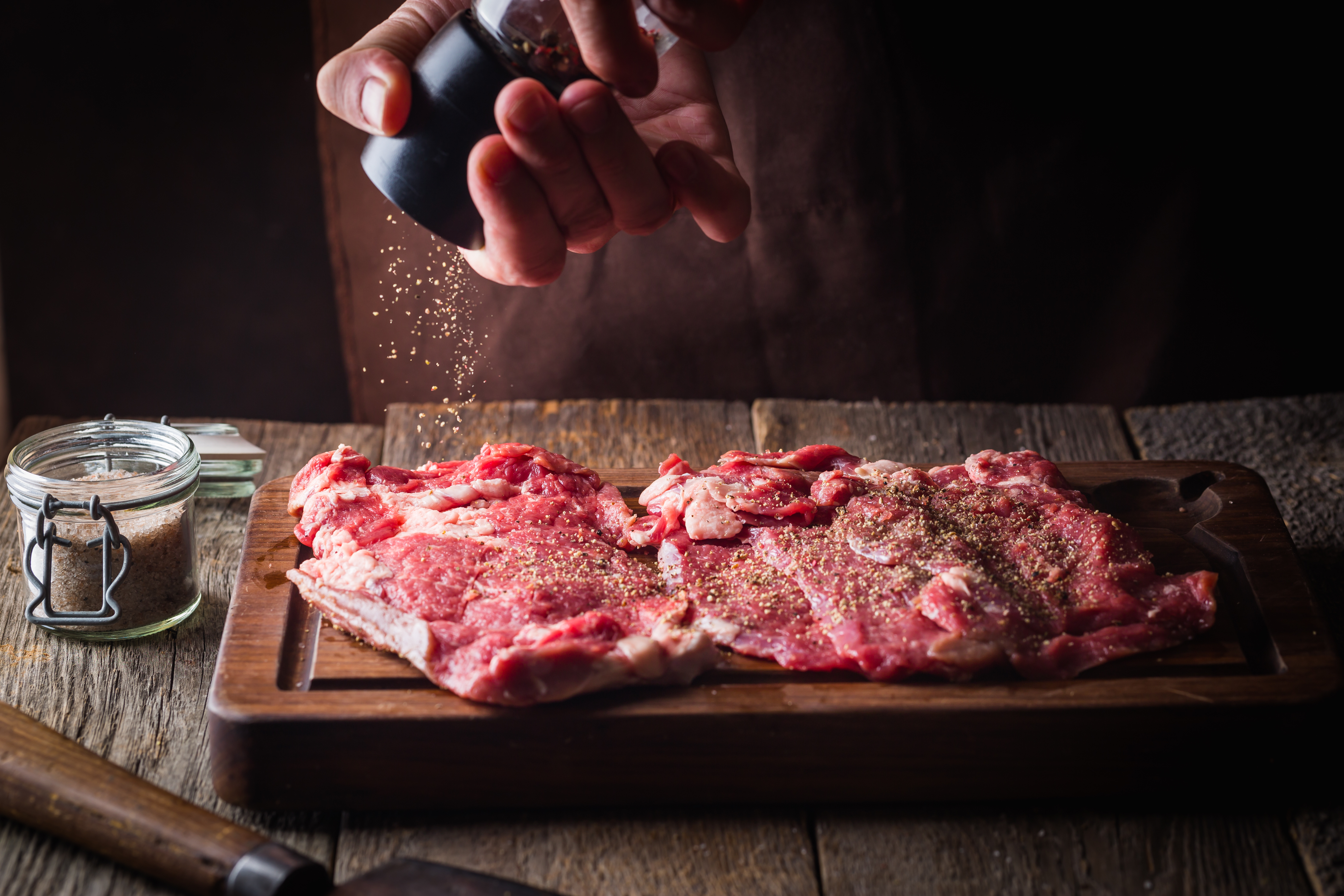 Man cooking meat steaks