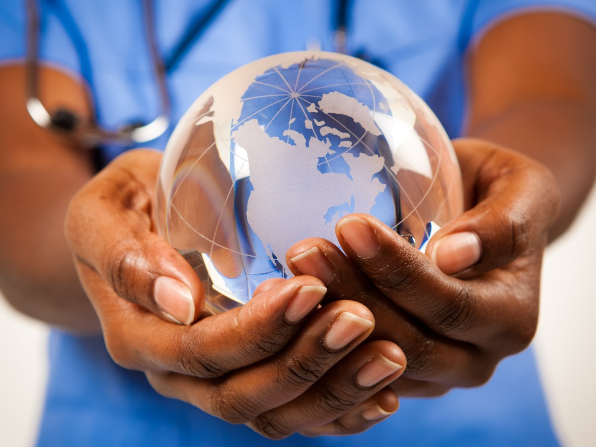 Nurse holds crystal globe in hands