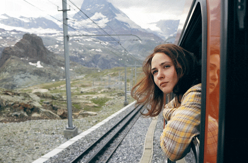 Woman looking out of the window on the train near the Matterhorn 