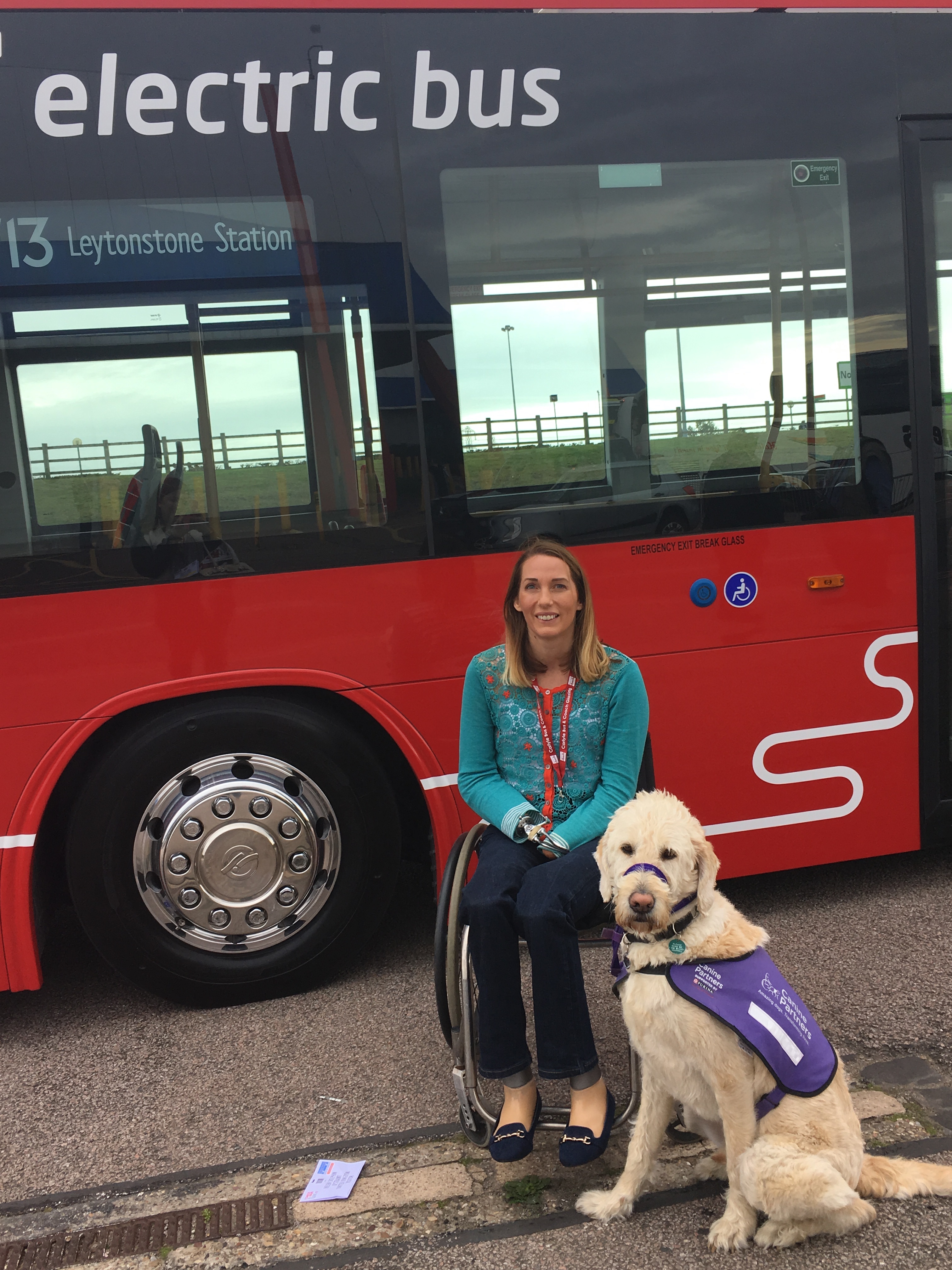 A guide dog sits beside Helen