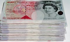 Pile of British bank notes.