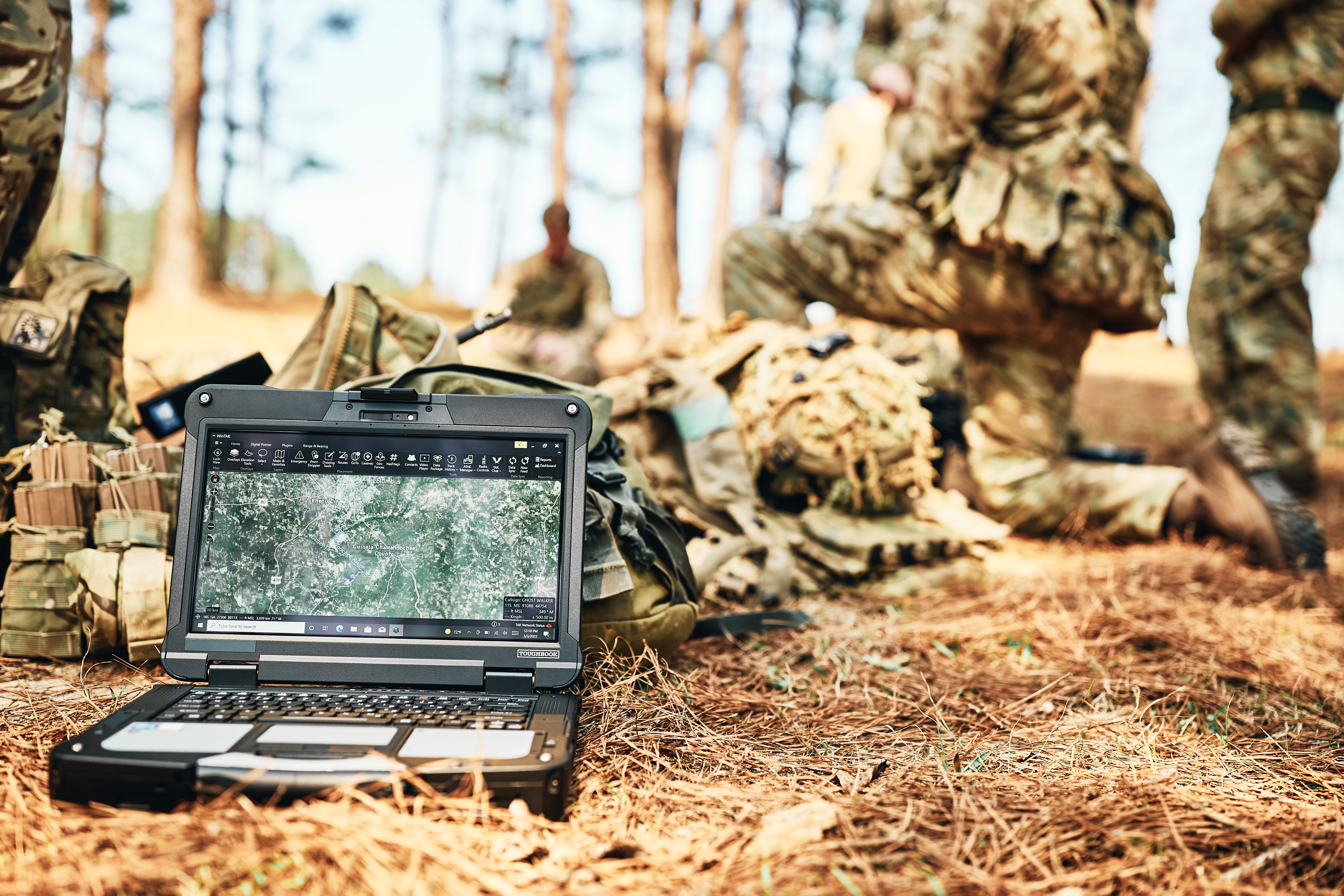 Soldiers in the field using military technology.