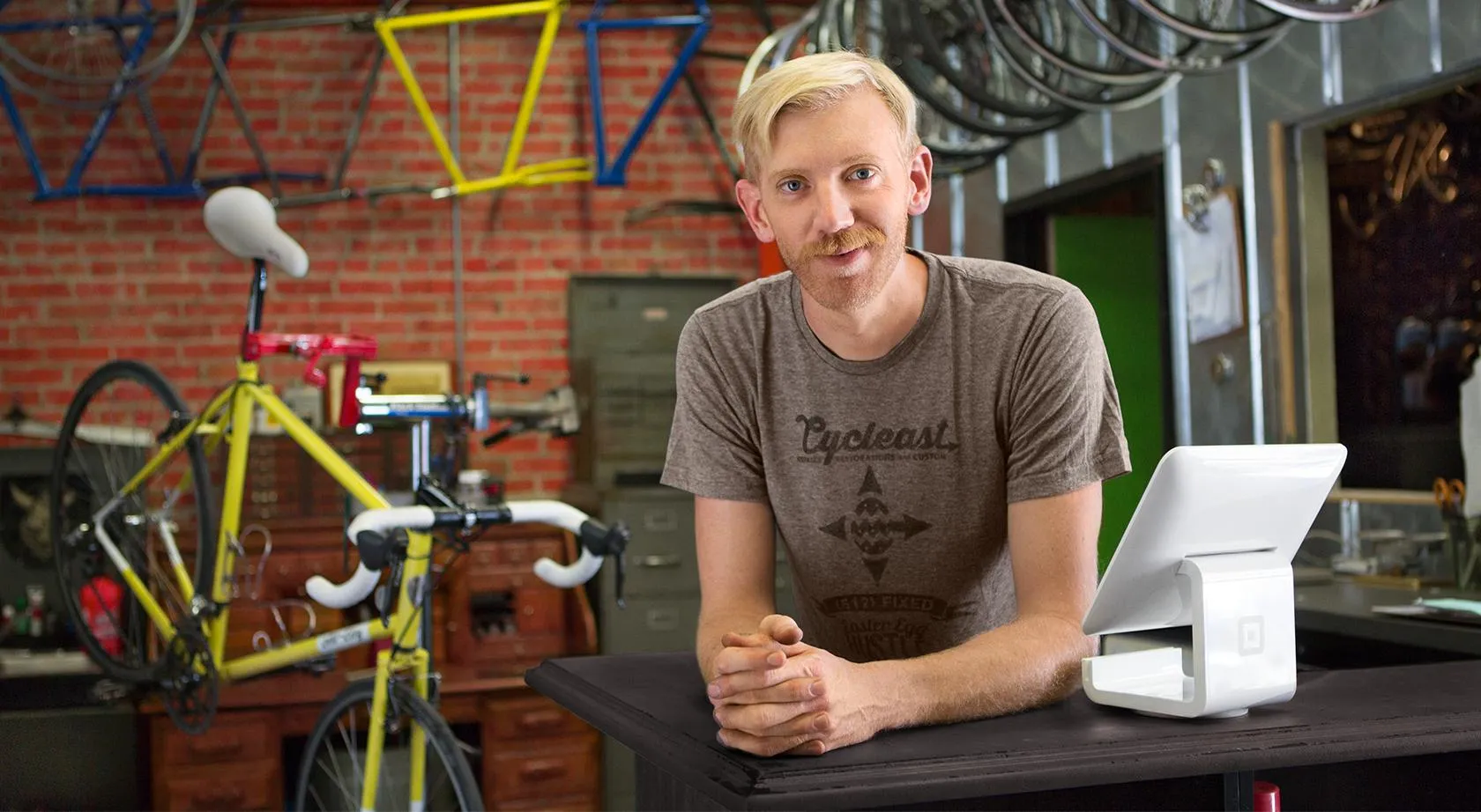 Man standing behind the counter of a bicycle repair shop