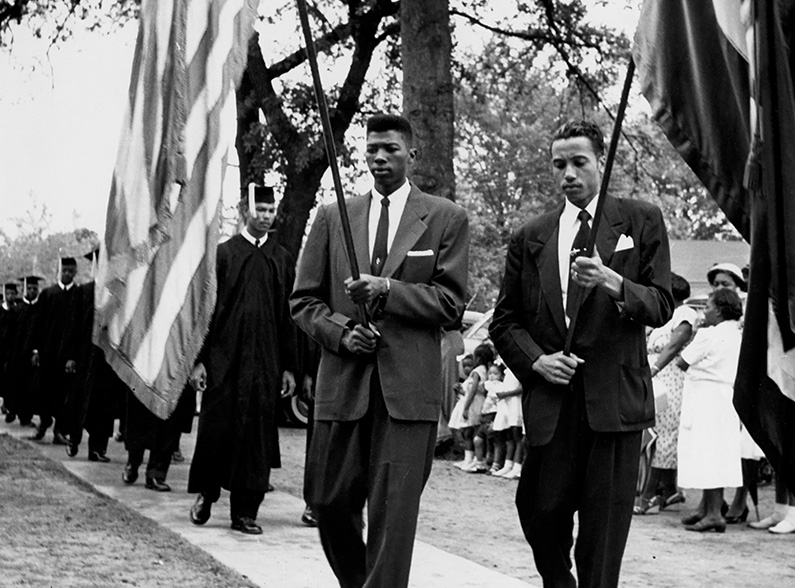 A black and white photo of a graduation flag ceremony from Claflin University.