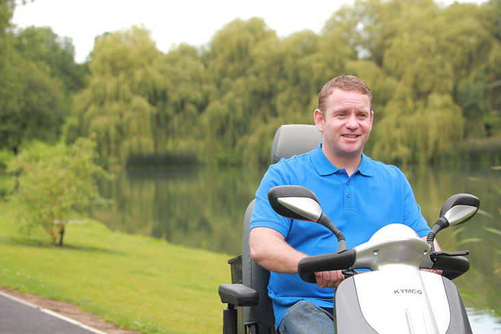 Motability Scheme customer driving scooter