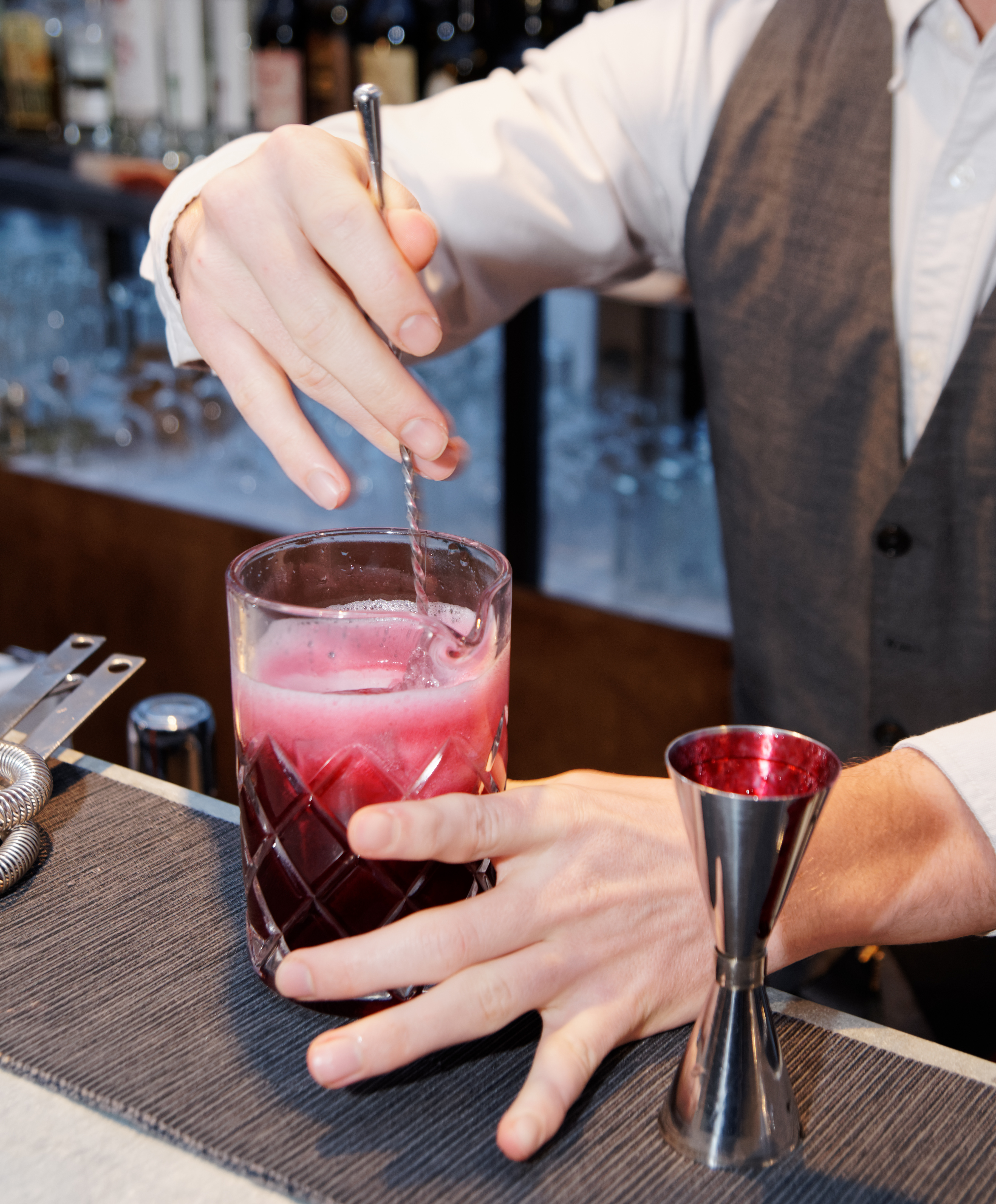 Bartender is stirring a shrub cocktail