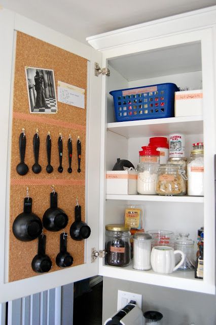 12 Easy Kitchen Organization Tips _ Cork board inside of kitchen cabinets to pin recipes and hooks for measuring spoons_.jpg