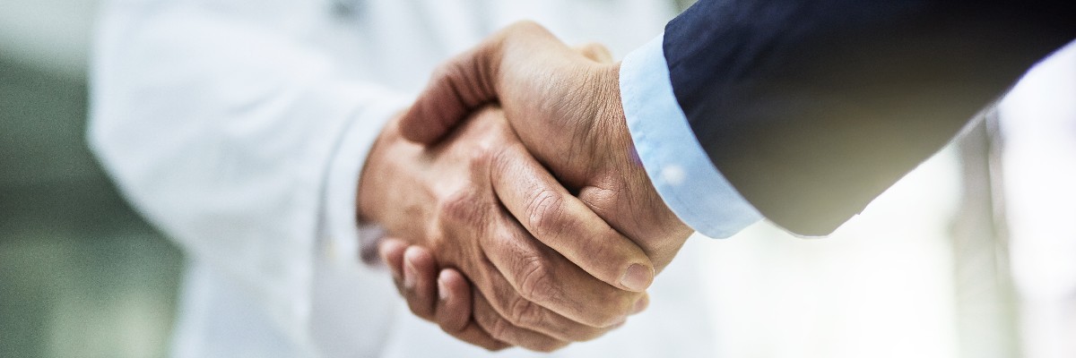 Cropped shot of a doctor shaking hands with a businessman