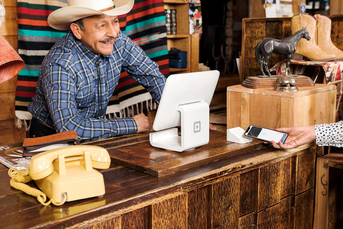 Man interacting with customer at register