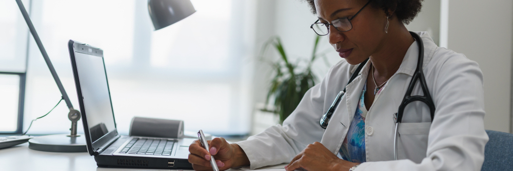 A doctor reviews paperwork in a clinic. 