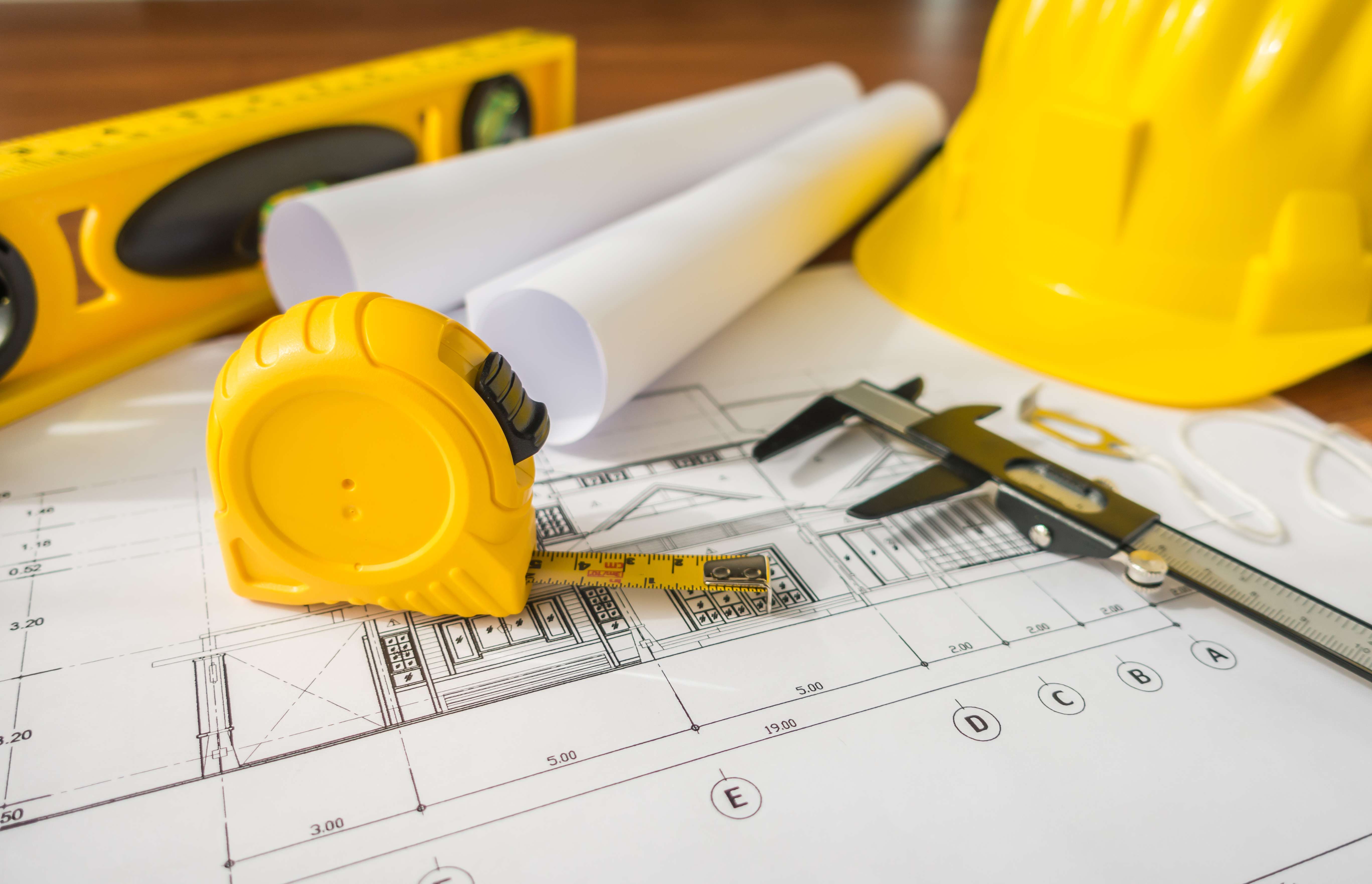 construction-plans-with-yellow-helmet-drawing-tools-bluep (1).jpg
