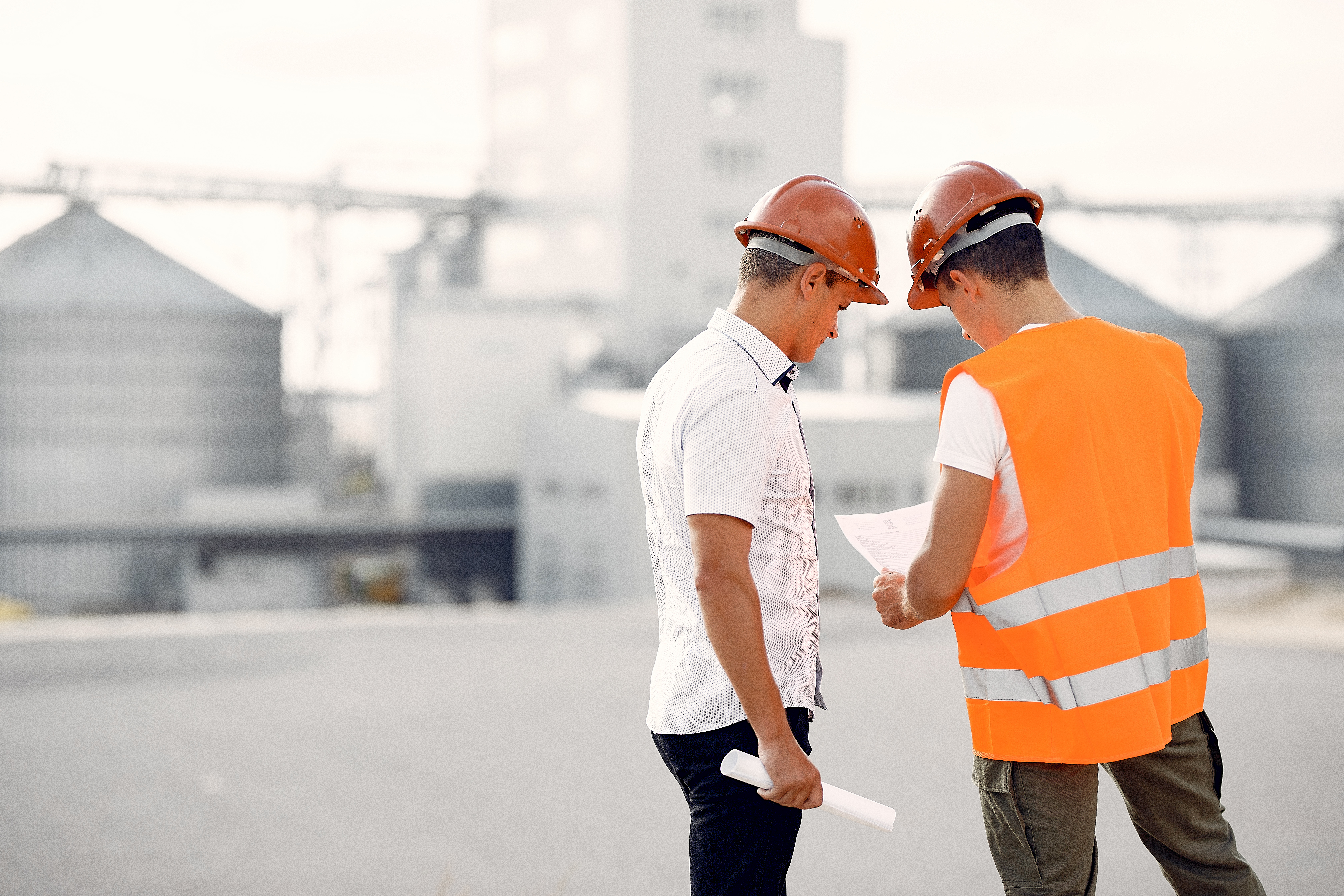 engineers-helmets-standing-by-factory.jpg