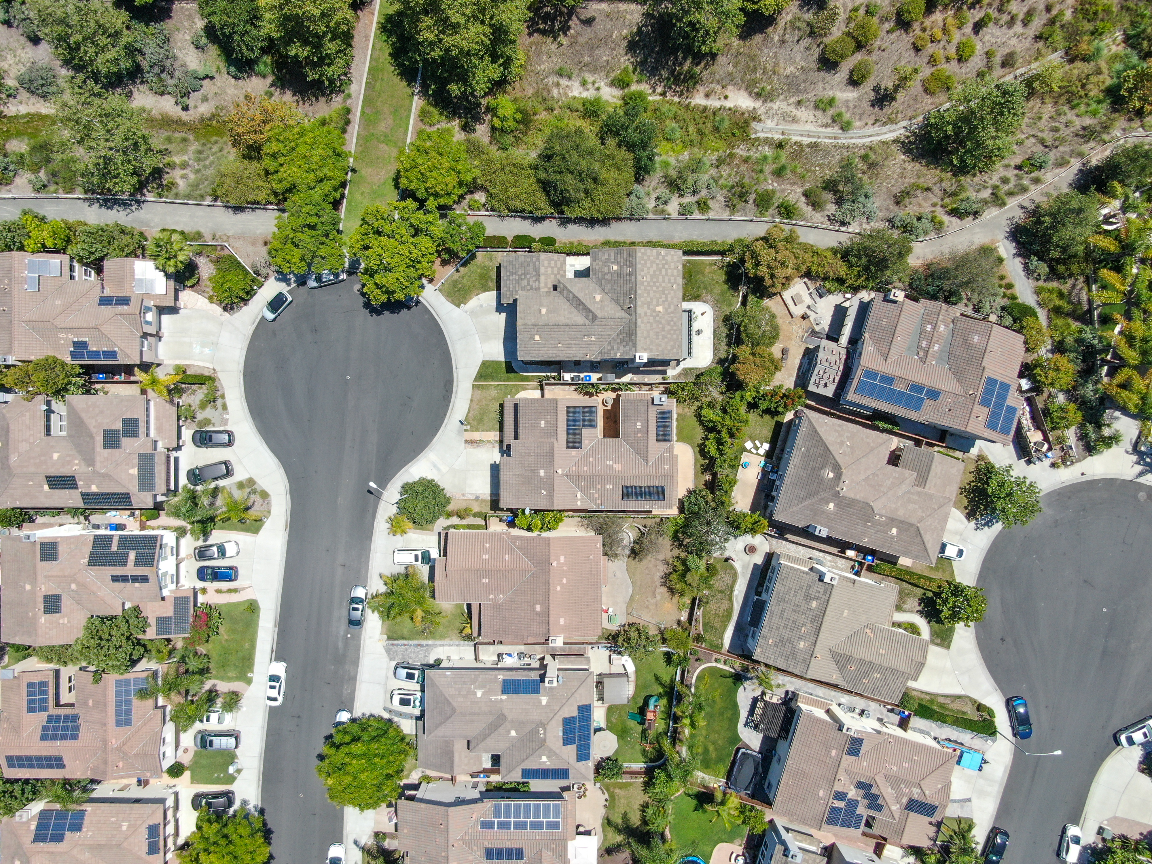 Aerial top view of middle class residential villas with solar panel on the roof