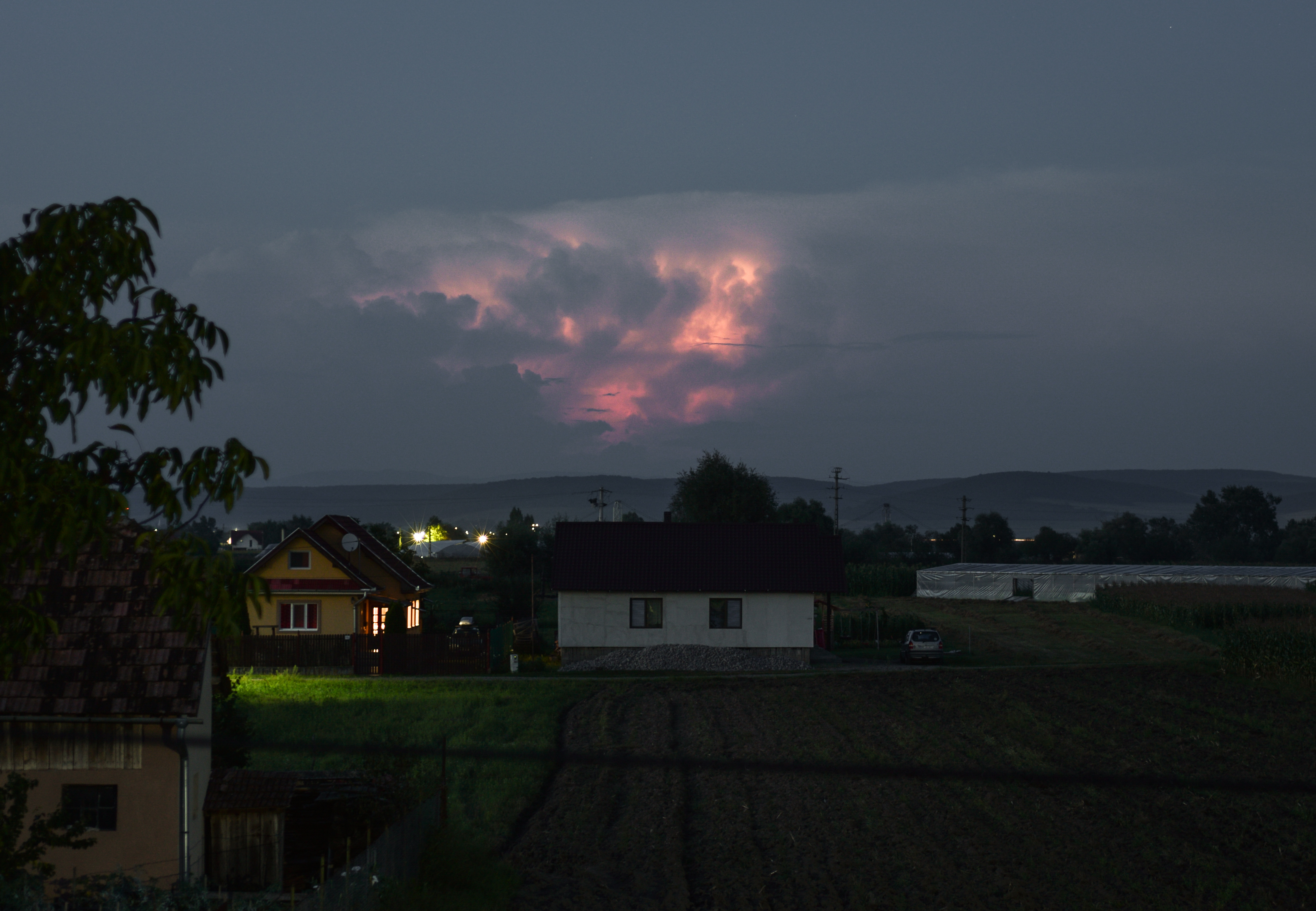 Lightning inside a thunderstorm cloud over the eastern Carpathian mountains in Romania