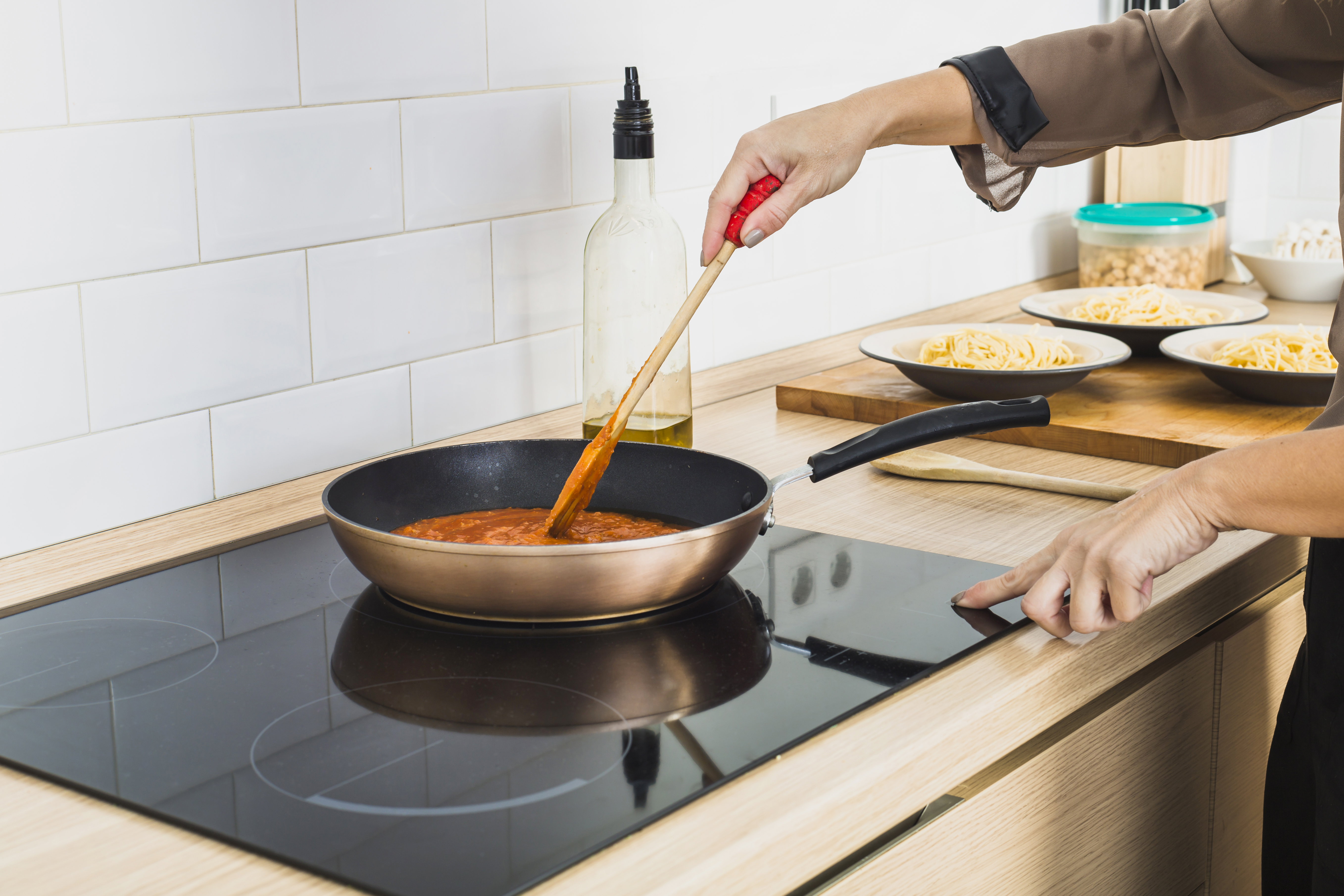 person-mixing-sauce-pan-stove.jpg