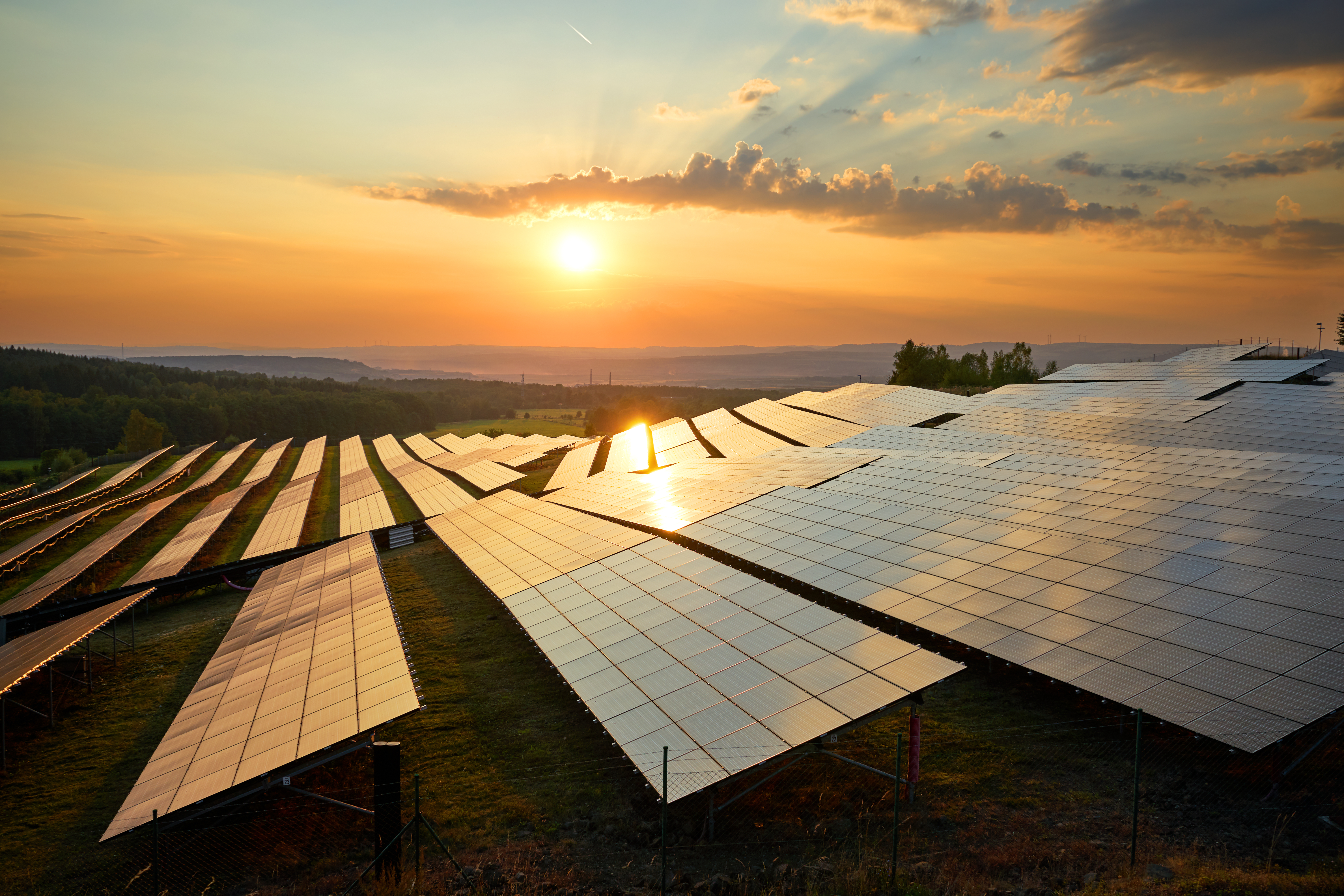 Photovoltaic panels of solar power station at sunset.