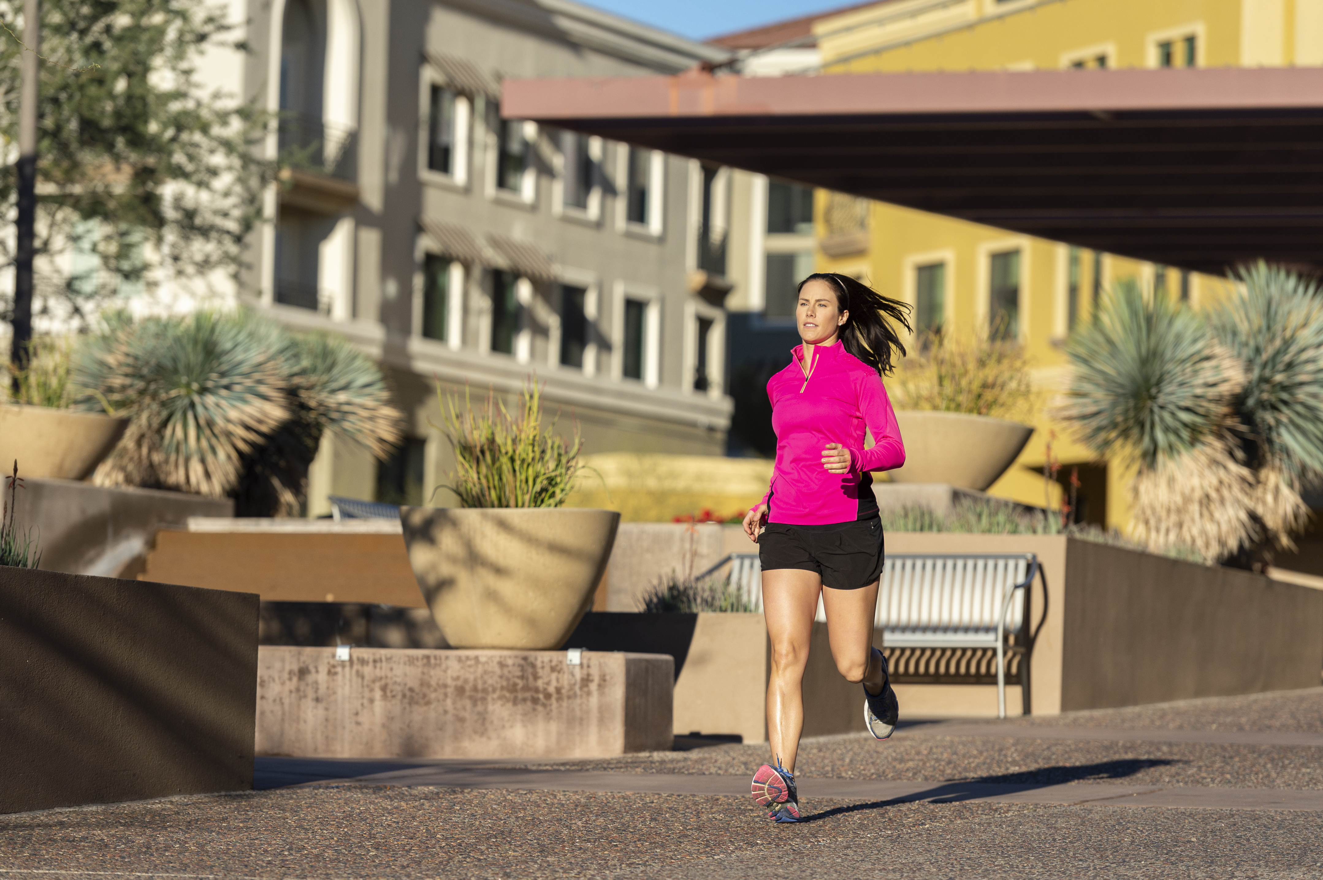 Beautiful Caucasian woman running in town