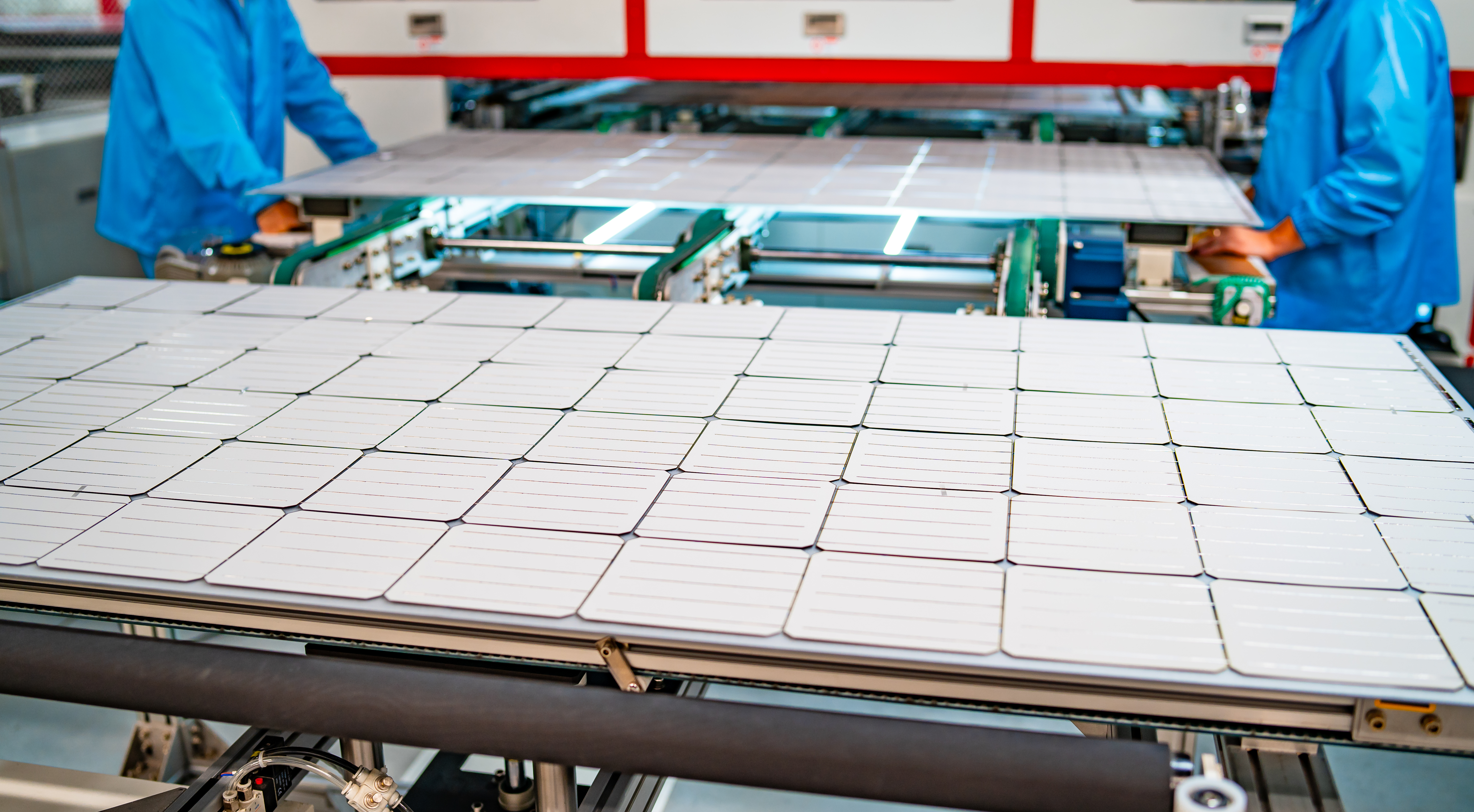 production of solar panels, men working in factory.