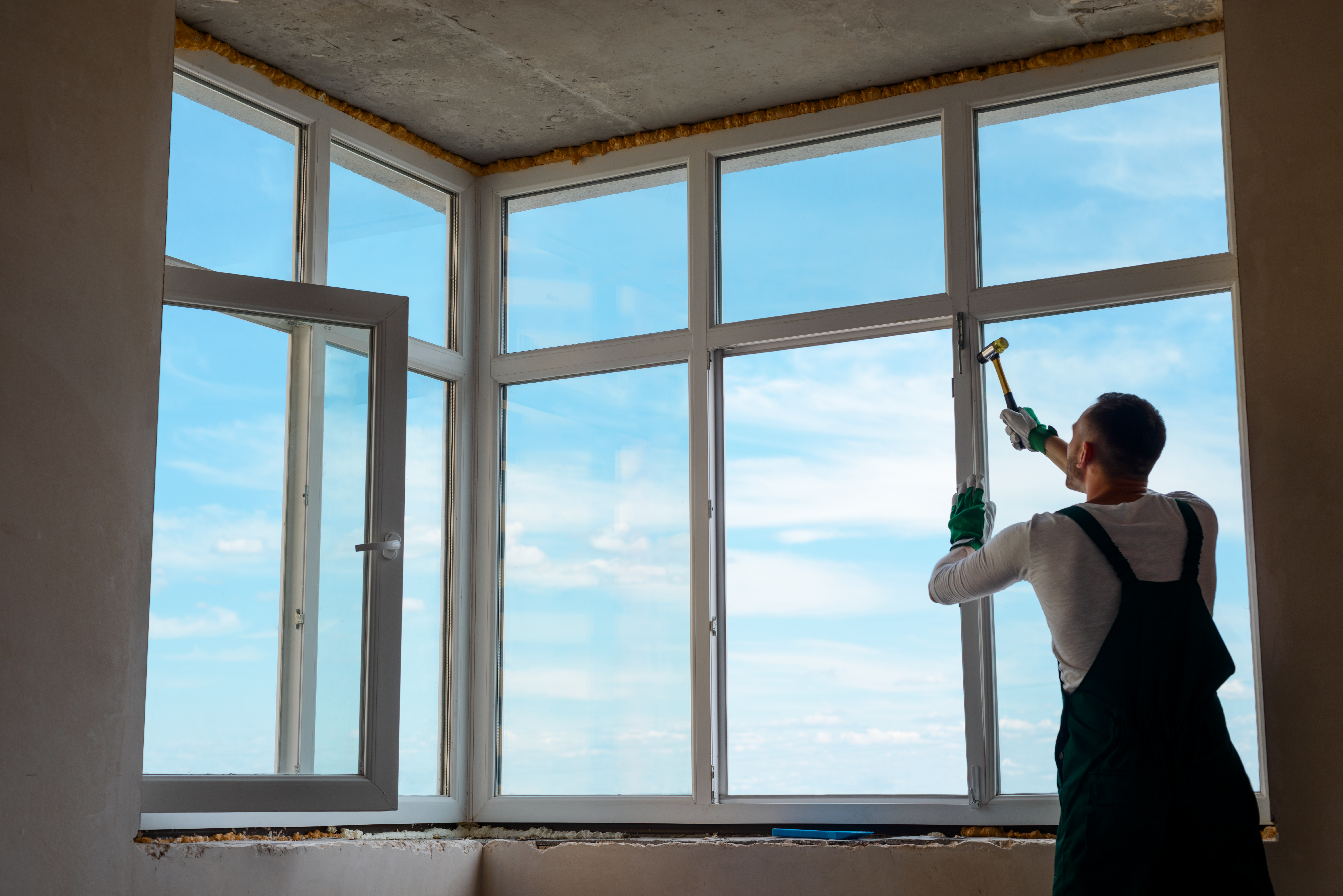 Builder is installing a window.