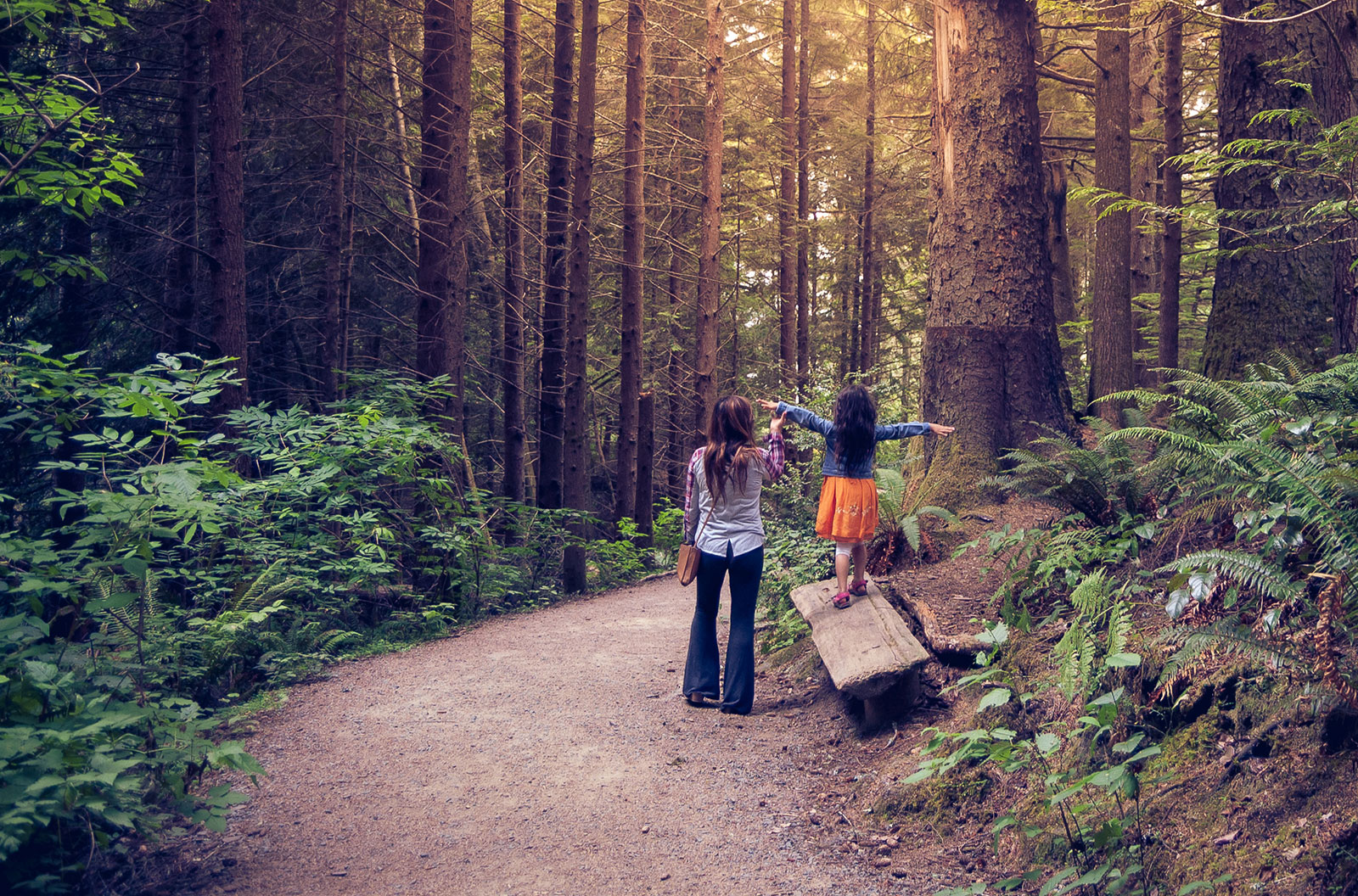 Mother and daughter walking together in Oregon forest