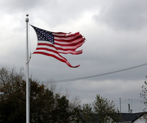 American flag stands tall, but tattered, after Superstorm Sandy