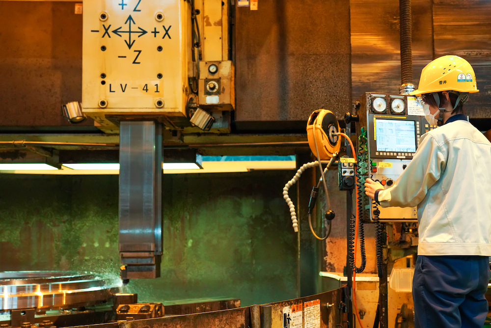 Ms. Sugai operating an NC lathe