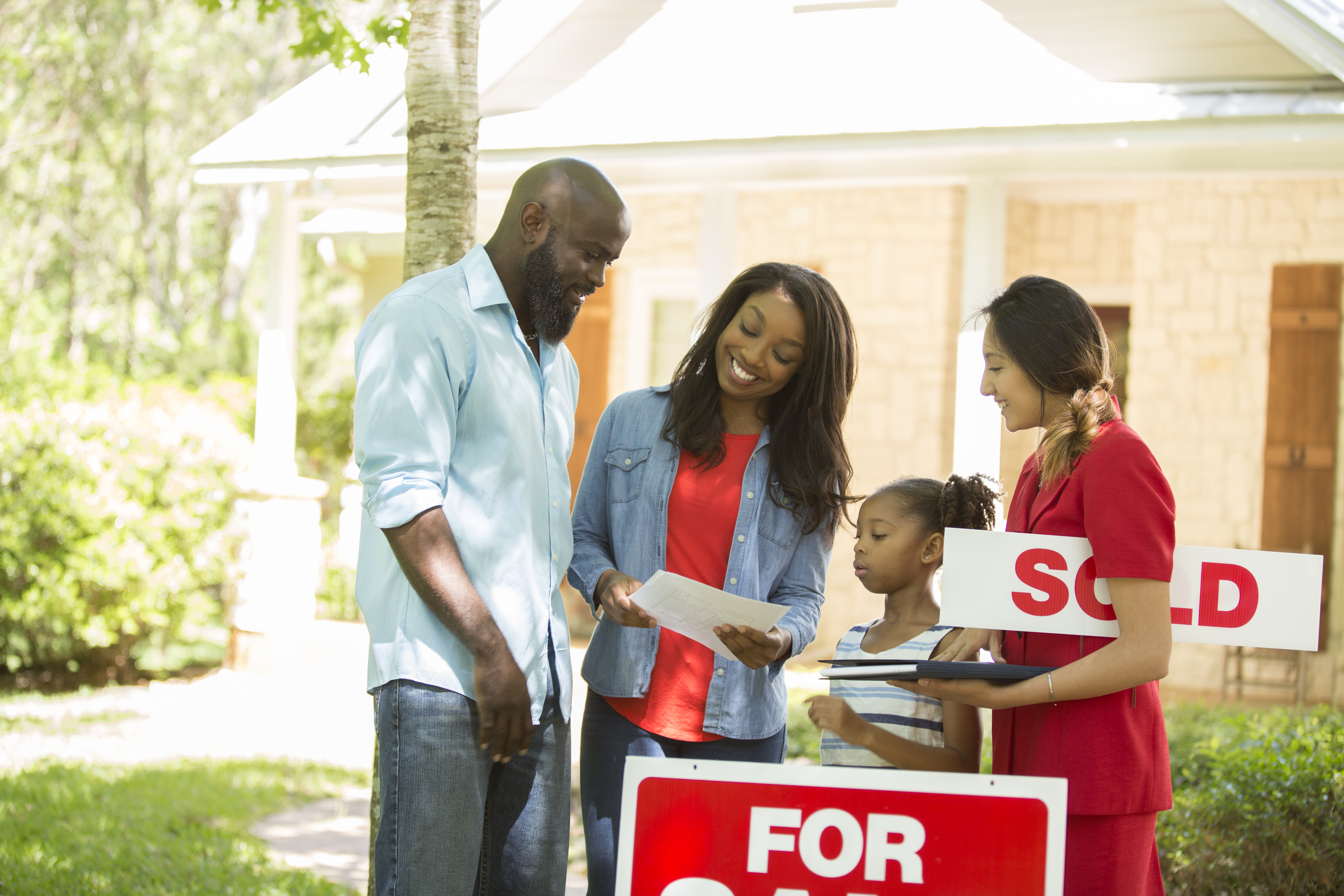 Realtor and family looking at new home to purchase.