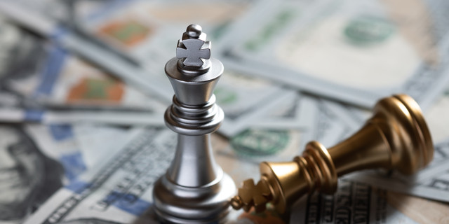 Chess king stand over fallen enemy on US banknote background. Business competition concept. Copy space.