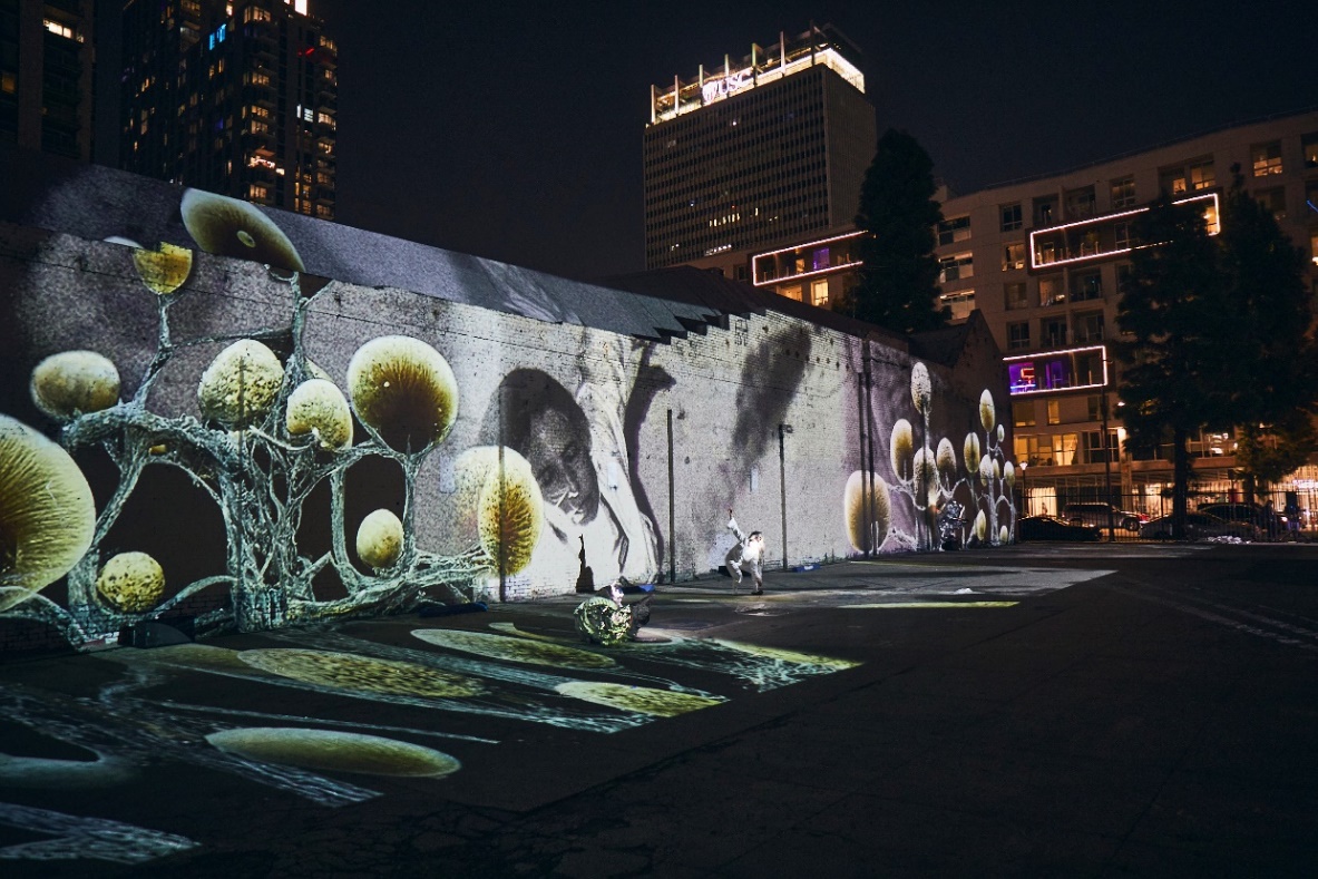 Projection mapping creates engaging, immersive experiences on a wall in a city at night.