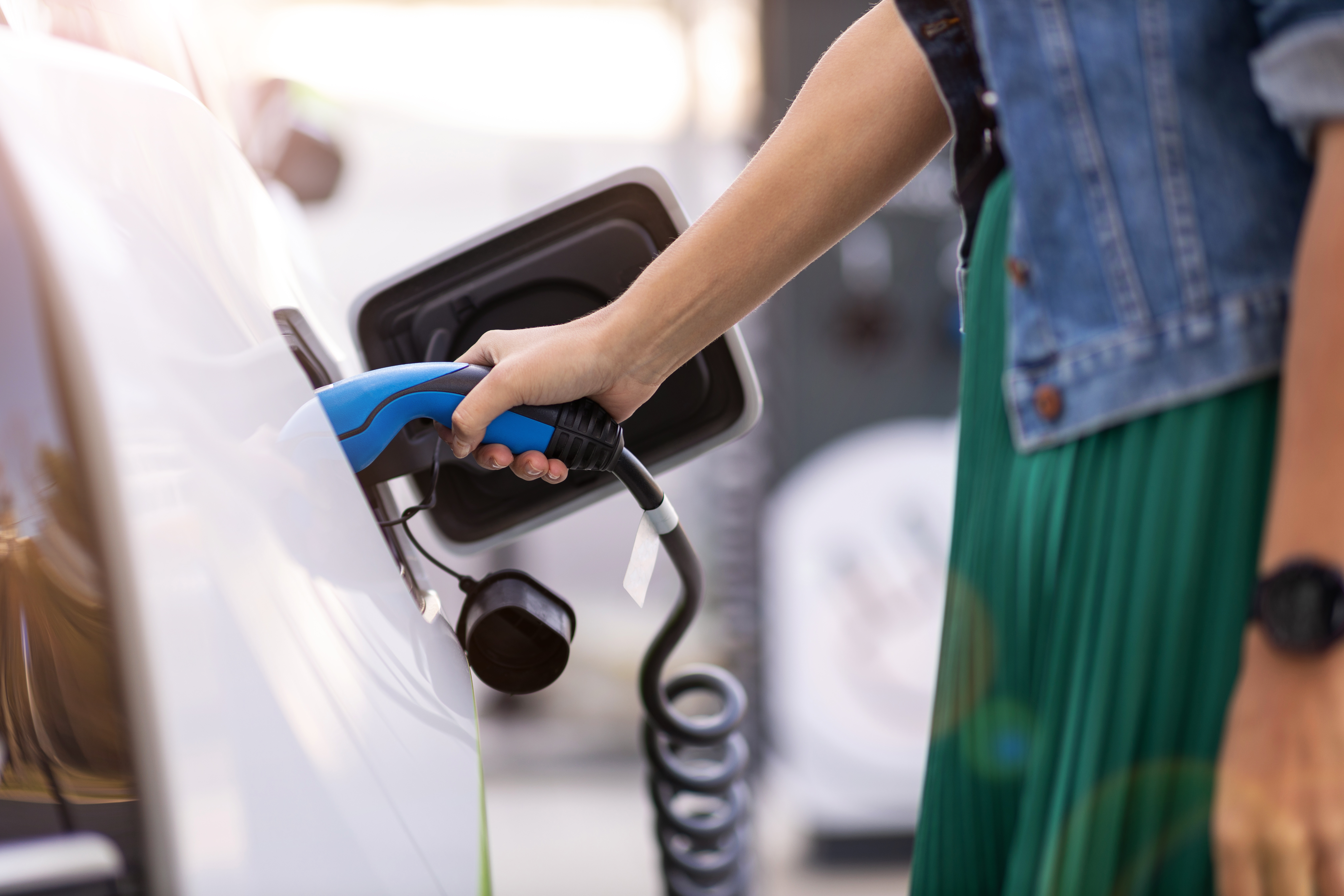 Woman charging of an electric car