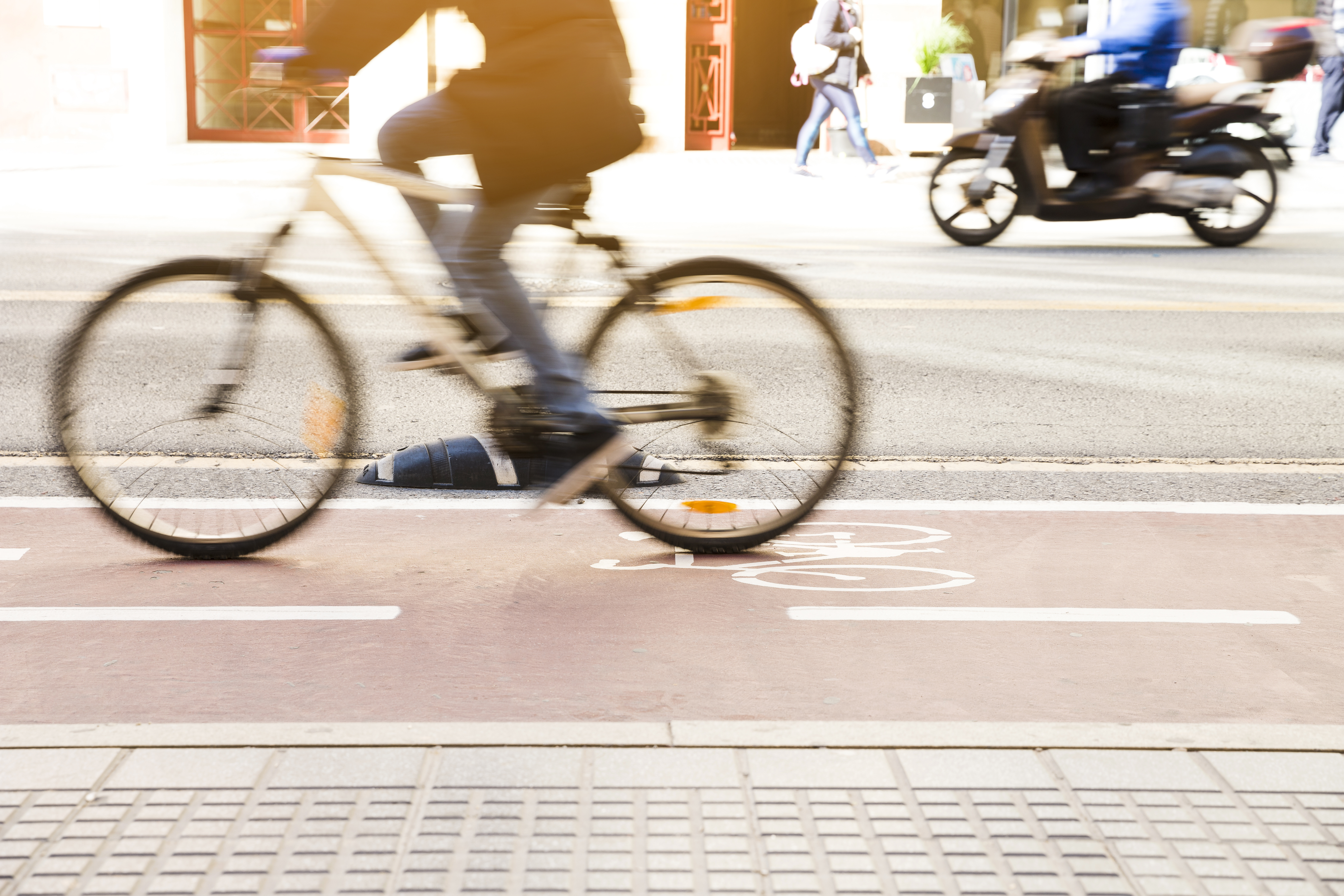 unrecognizable-cyclist-riding-bike-bicycle-lane-through-city-street.jpg
