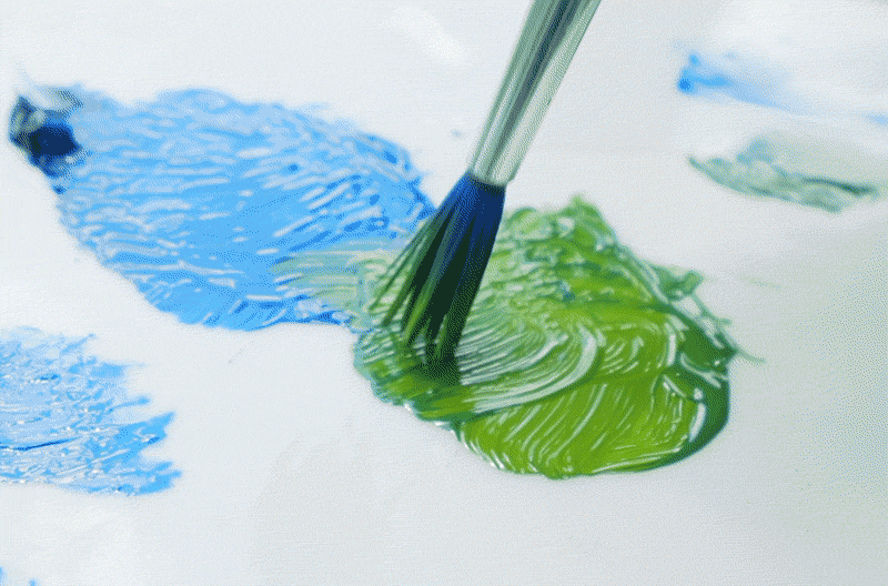An artist creates a new shade of paint by mixing two colors together