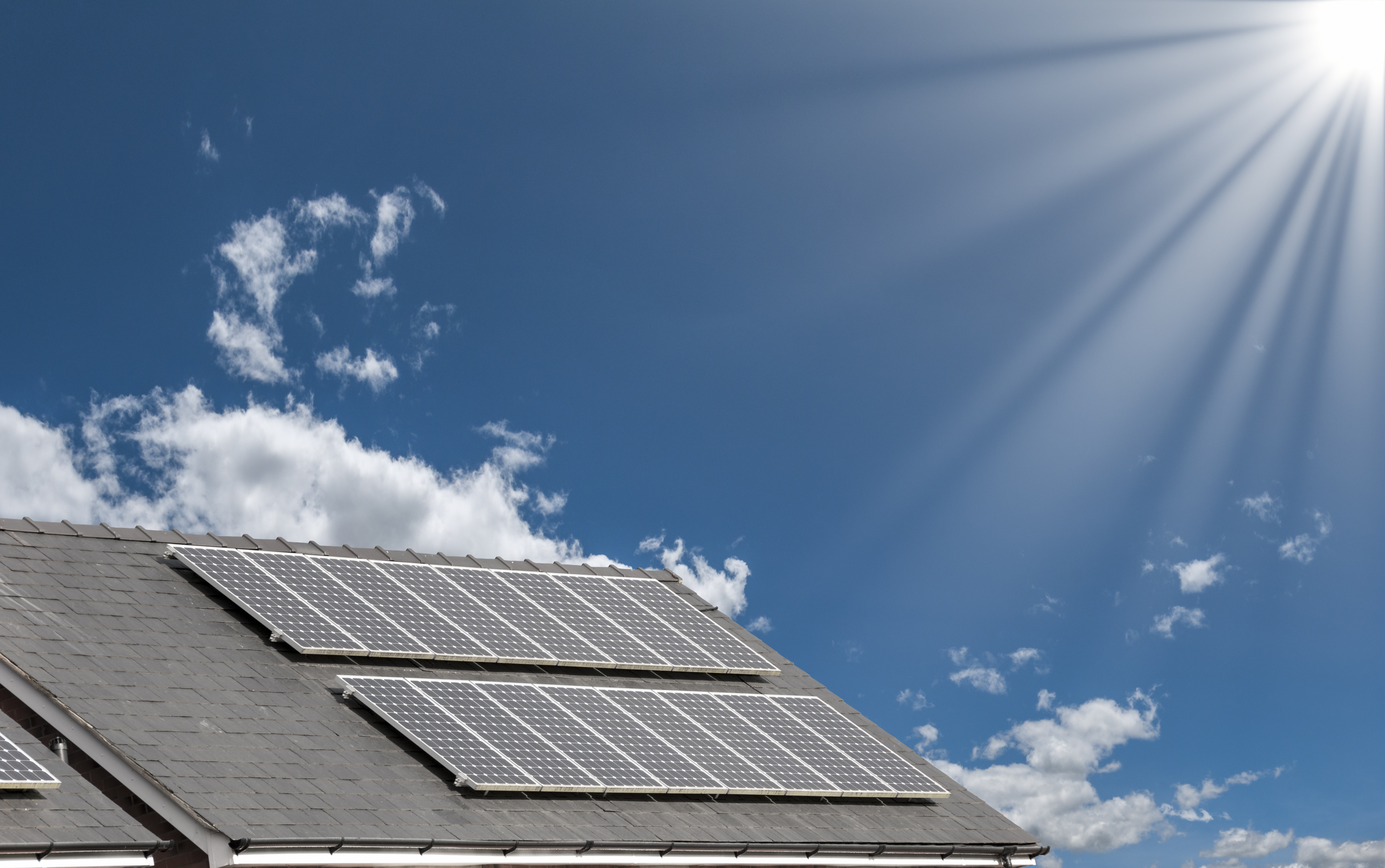 Solar Panels On The Roof Of A House Under A Bright Sunny Sky