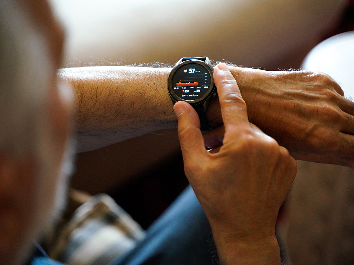 A man uses a smartwatch to check his heart rate.