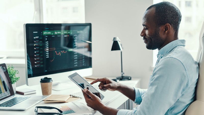 adviser-looking-at-ipad-and-stocks.jpg