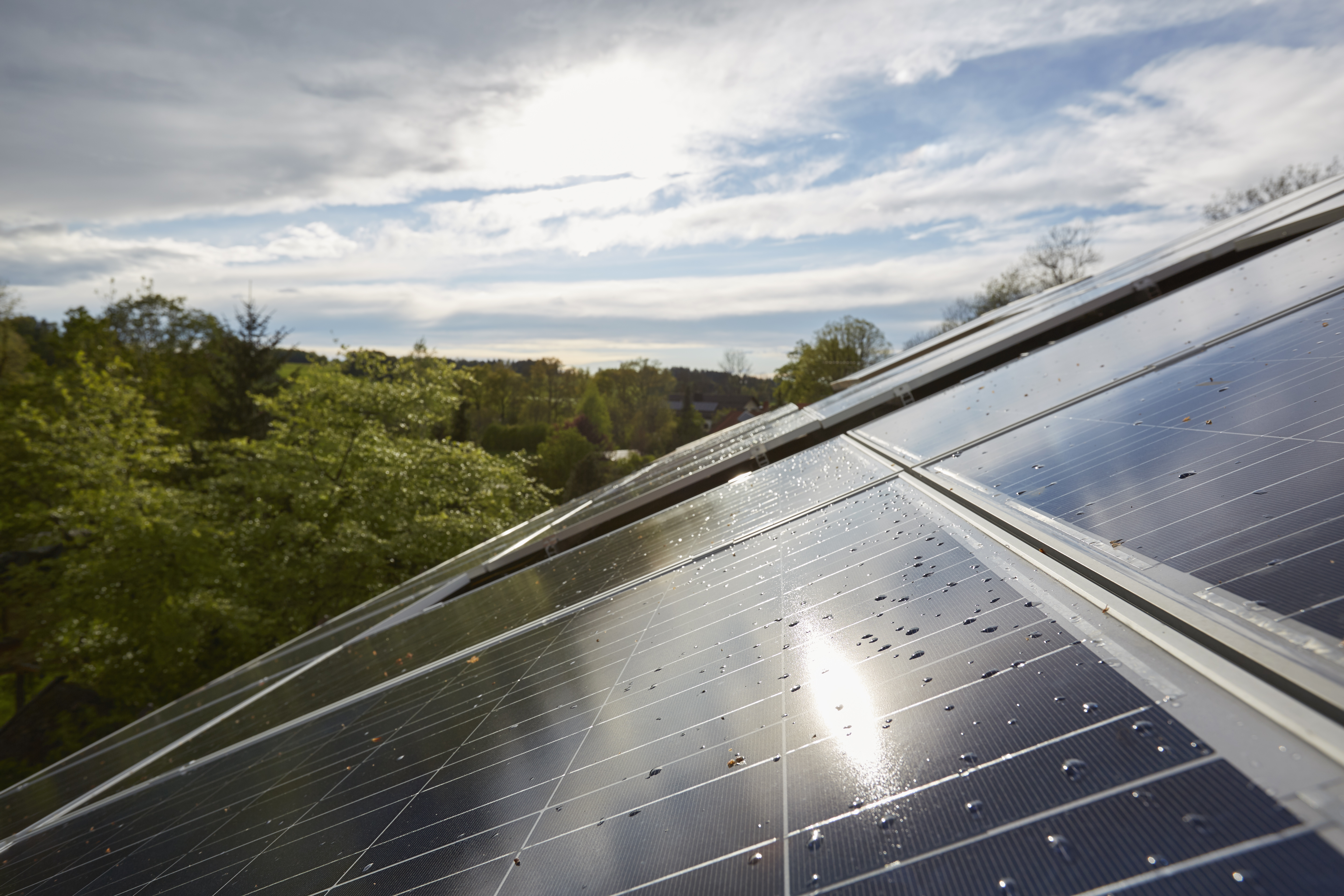 Elevated close up of sunlit solar panels on house roof