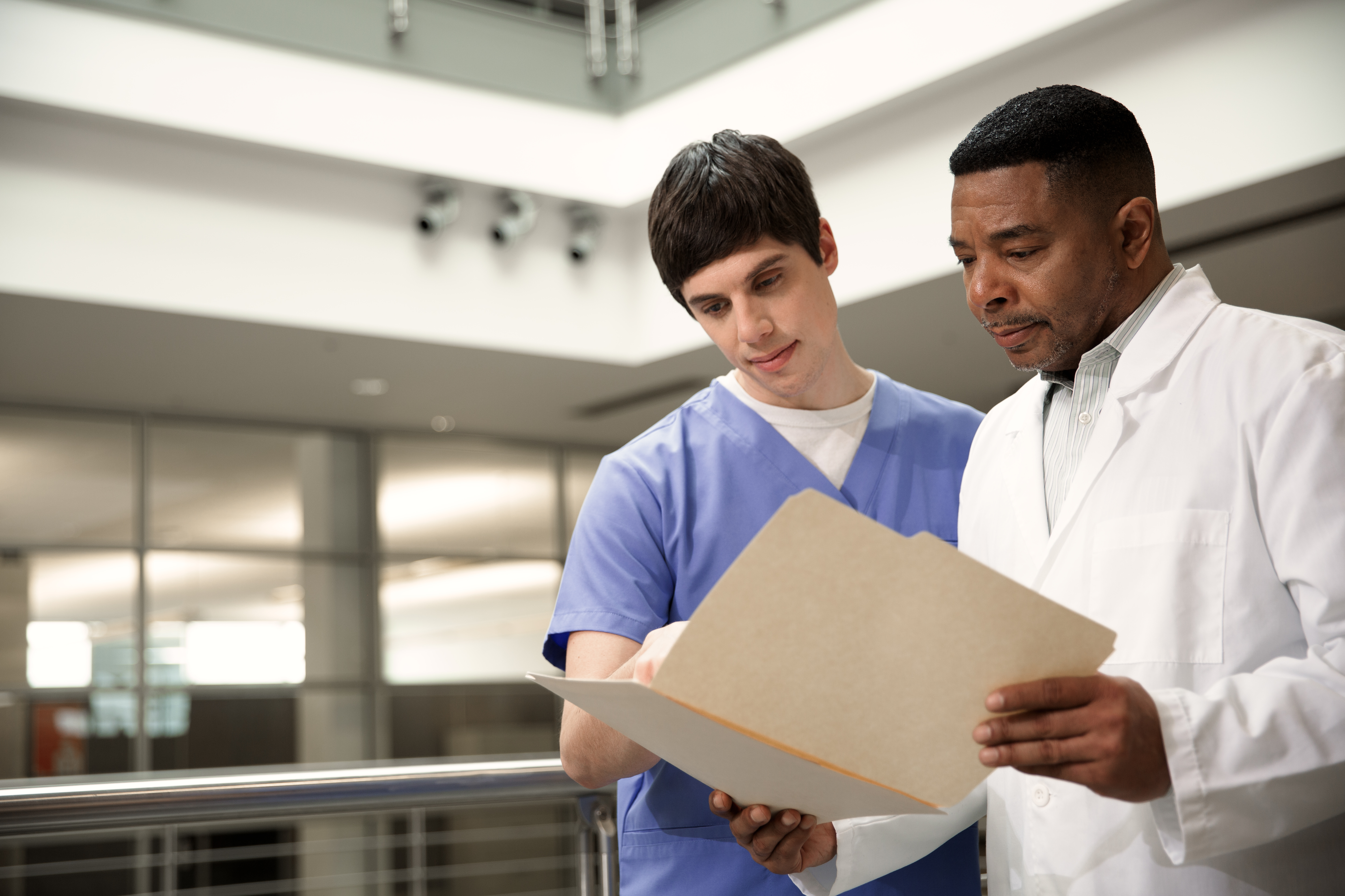 Radiologist and technologist reviewing clinical X-ray image
