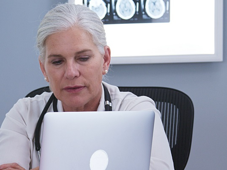 Cardiologist reviews laptop information