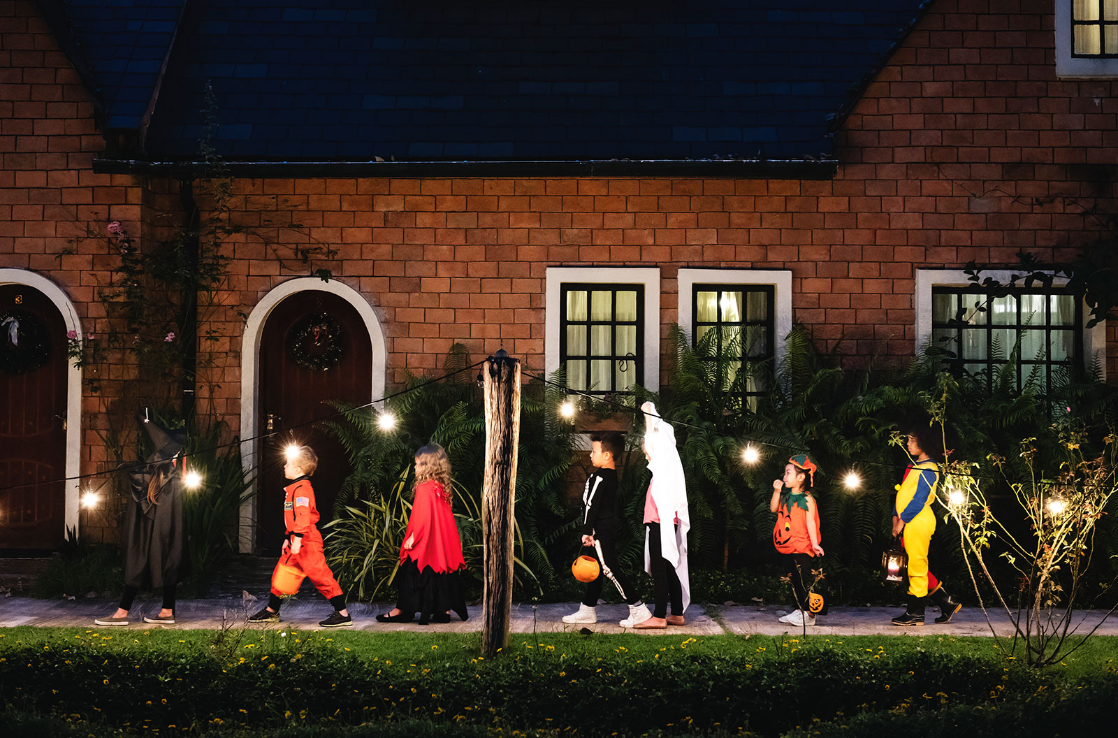 Group of kids with Halloween costumes trick or treating