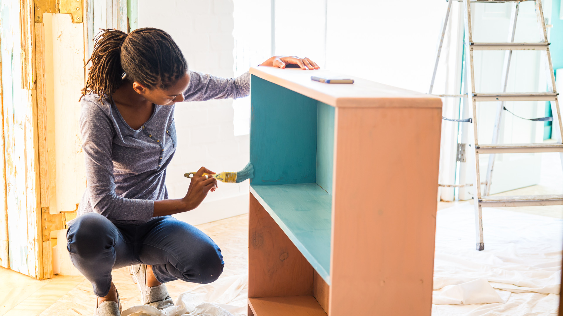 Young Afro-Caribean woman renovating her home