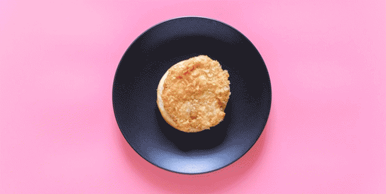 Stop-motion video of a chicken sandwich being assembled with fresh vegetables and fried chicken. 