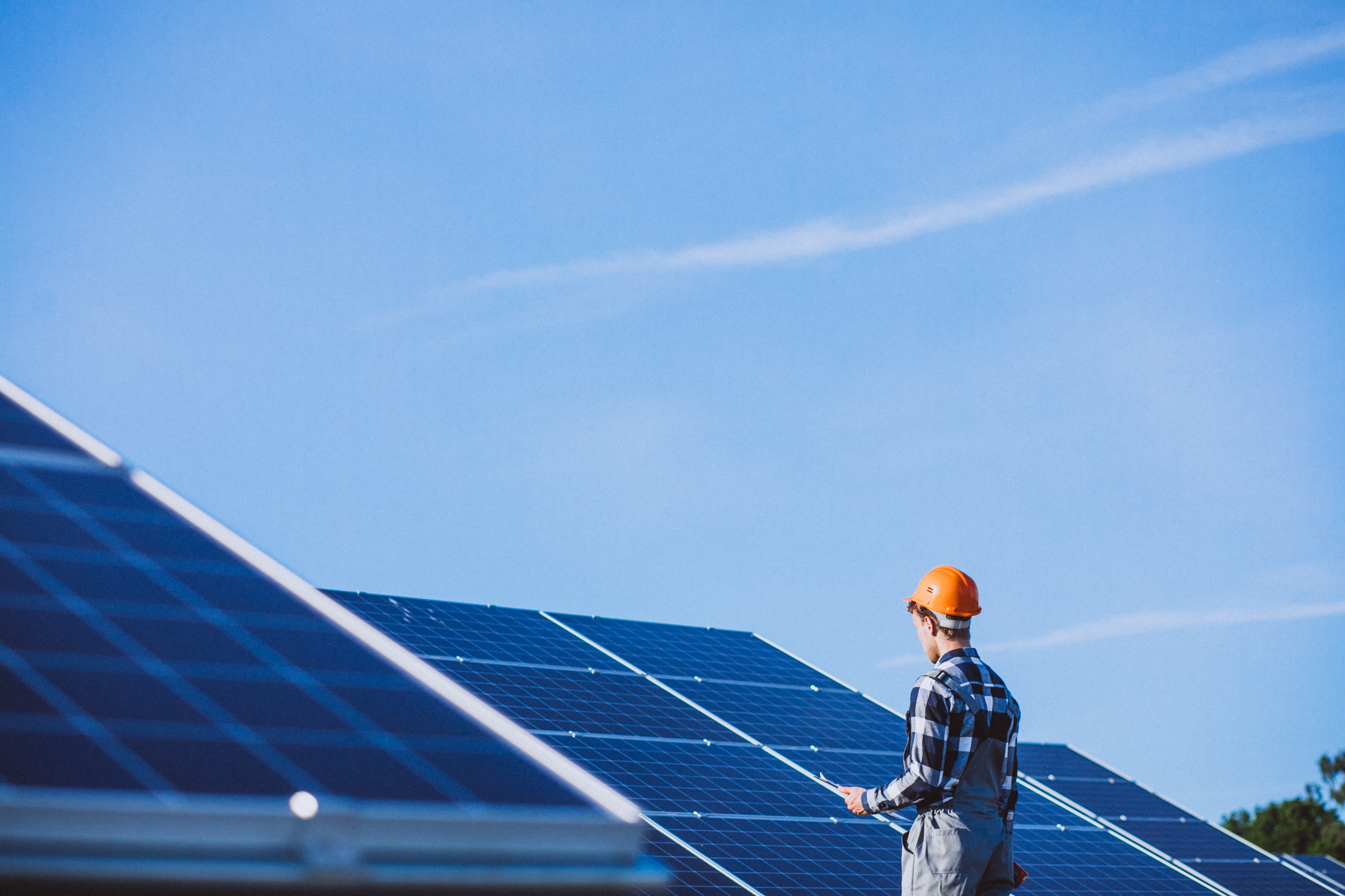 man-worker-firld-by-solar-panels.jpg